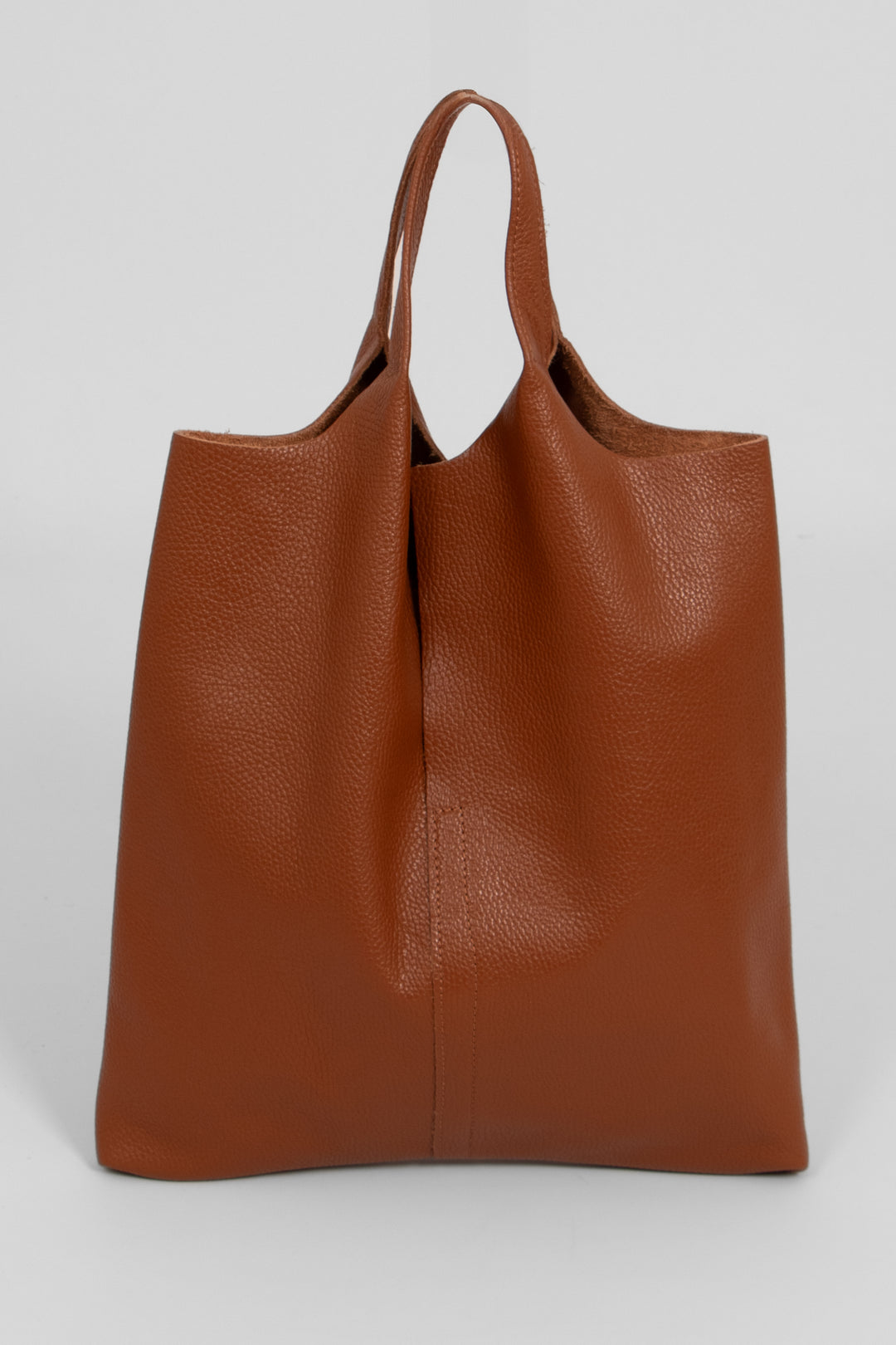 tan brown pebbled leather tote bag with top carry handles. this bag is designed to be worn over the shoulder