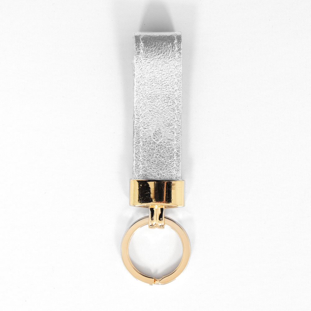 metallic silver leather loop keyring with a gold loop attachment. 