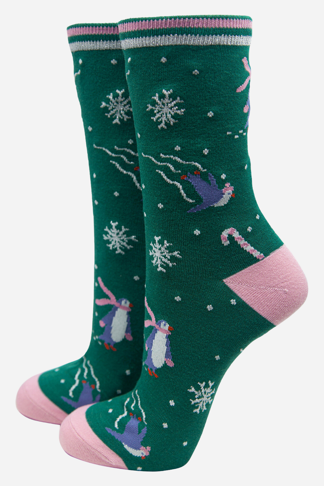 green socks with pink heel, toe and stiped cuff with a pattern of ice skating penguins, candy canes and snowflakes, with silver glitter accents