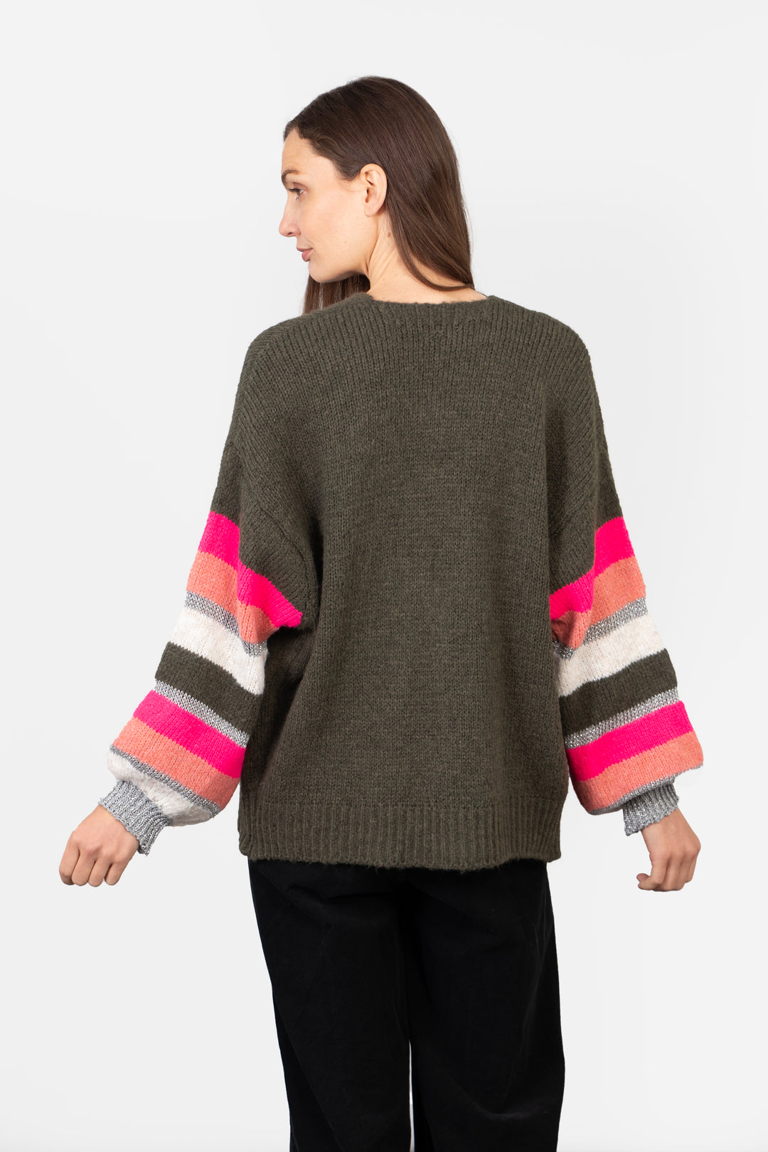 model showing the back of the cardigan, the back is plain khaki green, the sleeves have all round colourful stripes