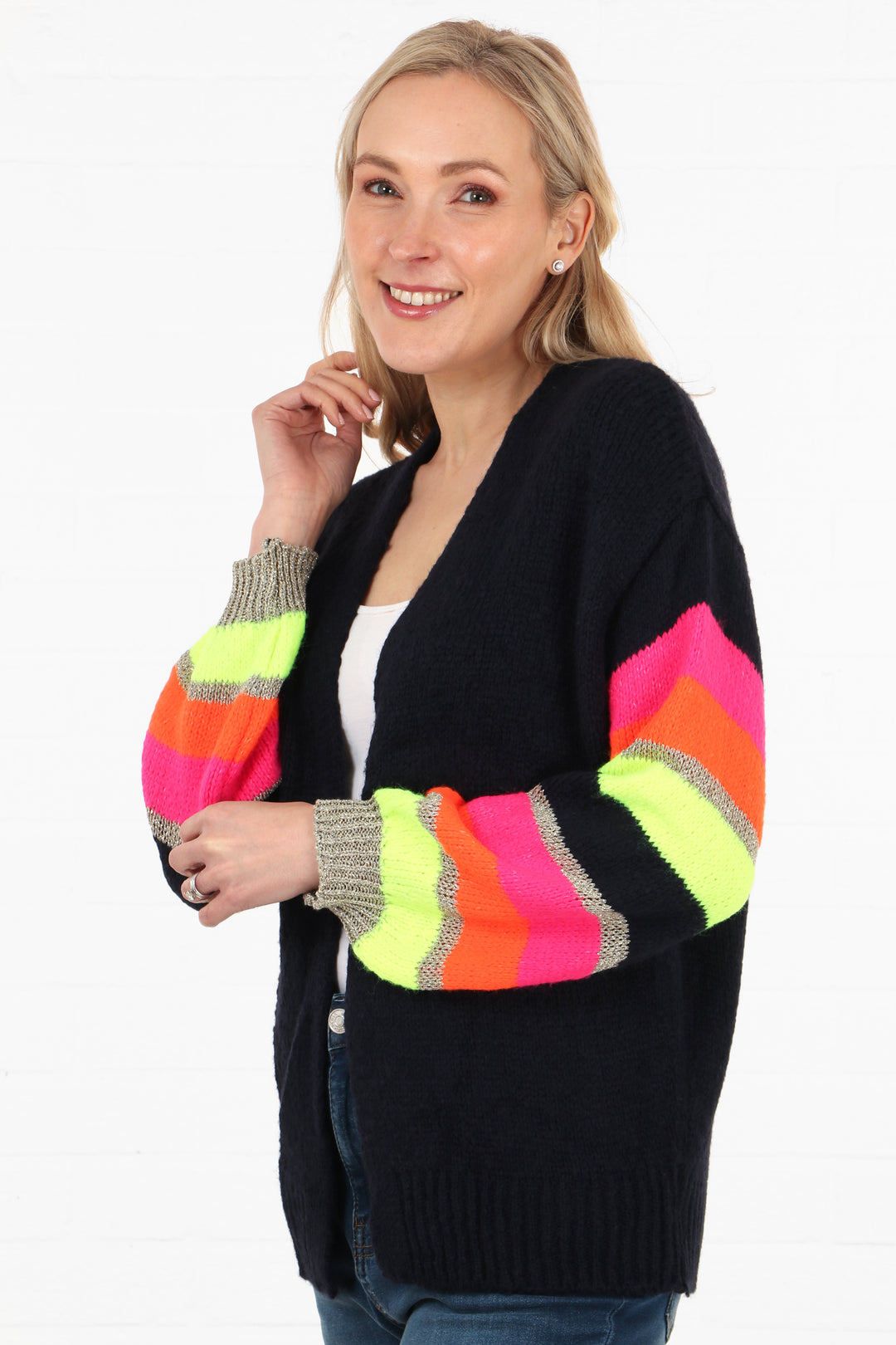 model showing a side view of the open front wool cardigan showing the multicoloured striped sleeves