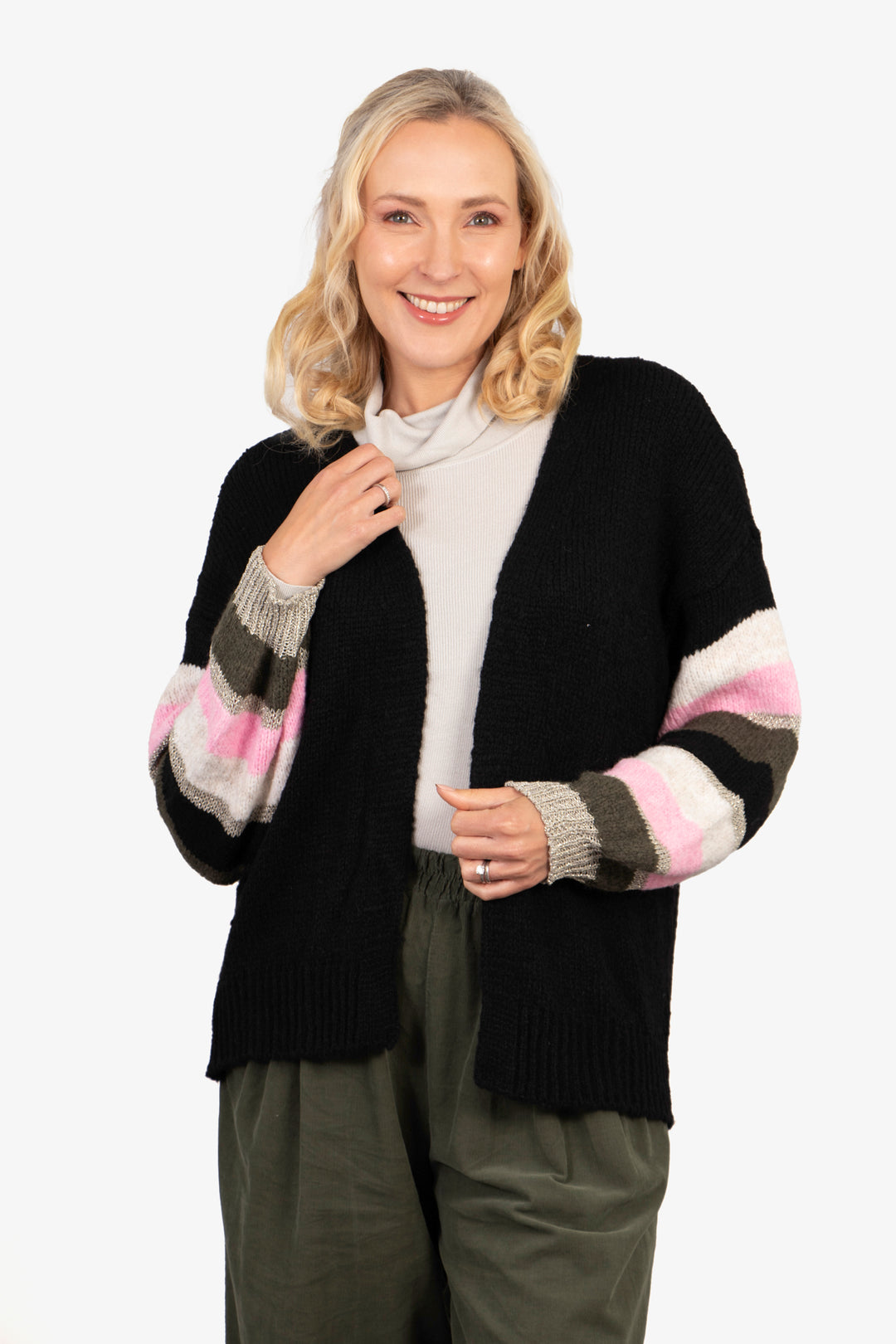 model wearing an open front black cardigan with pink, khaki and gold glitter striped balloon sleeves. the cardigan in open front and hangs on the hips