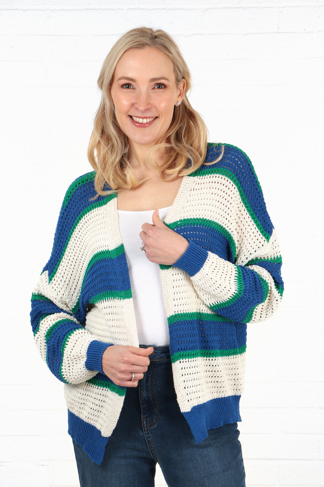 model wearing an open front knit cotton cardigan with cream, blue and green stripes