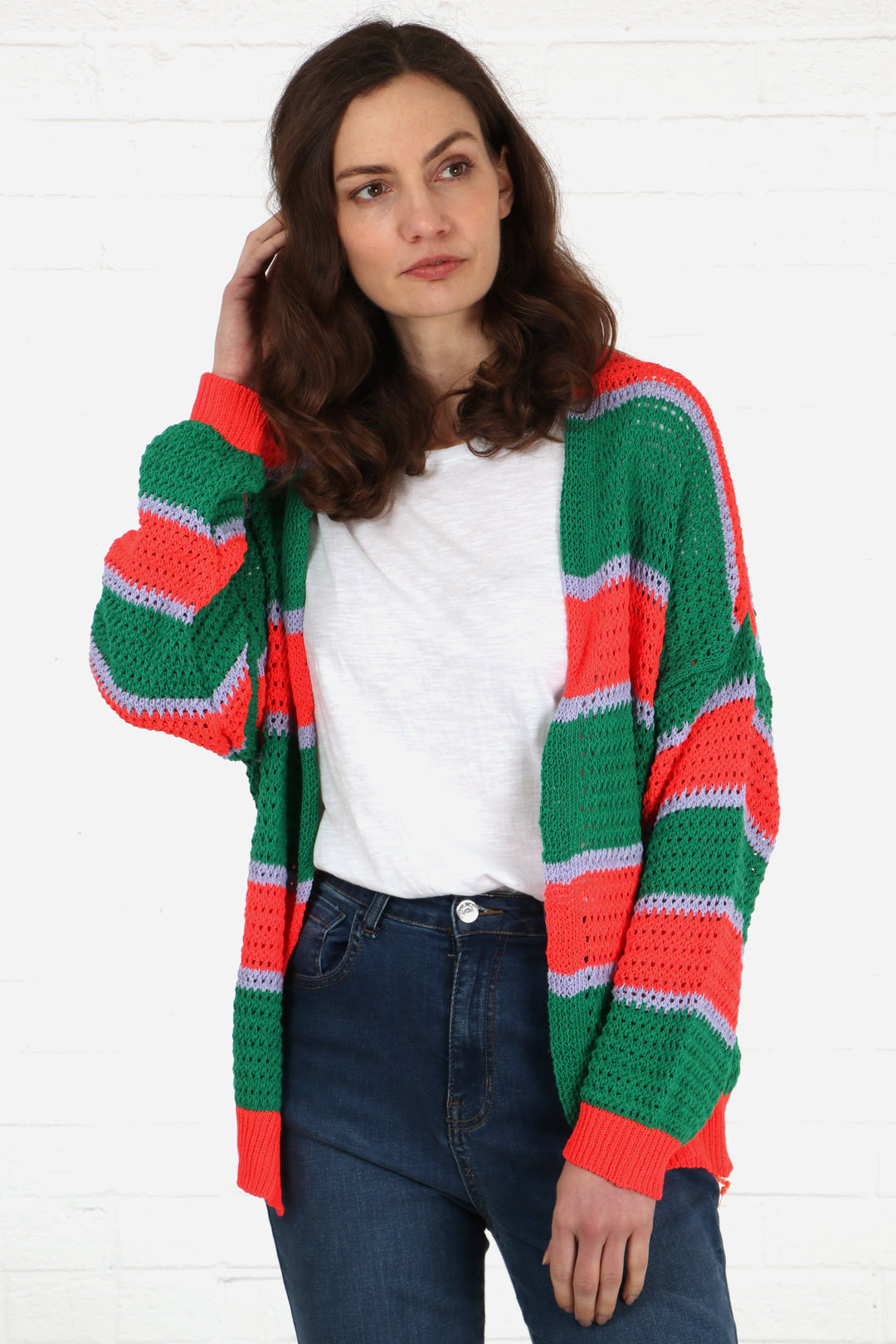 model wearing an open front knit cotton cardigan with green, orange and lilac stripes