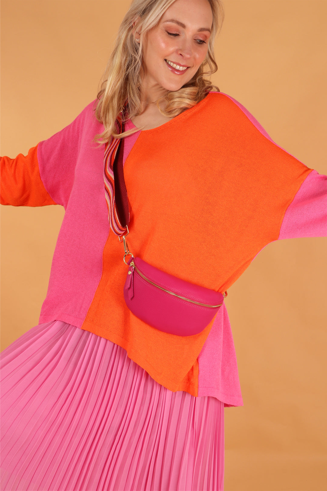 model wearing the fuchsia pink half moon bag across the body 