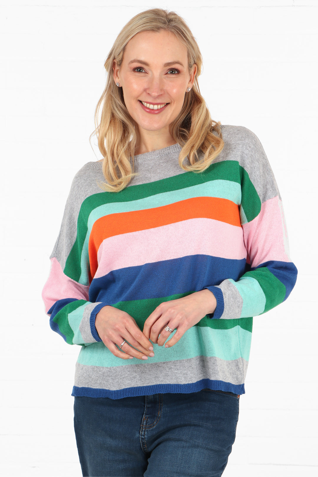 model wearing a light grey and multicoloured striped long sleeve cotton jumper with a slash neck and long sleeves