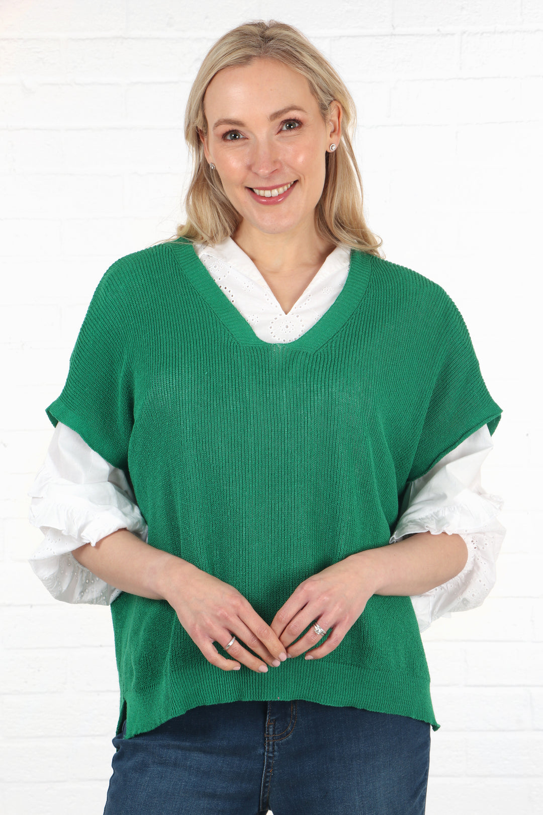 model wearing a green cotton fine knitted sleeveless tank top jumper in green