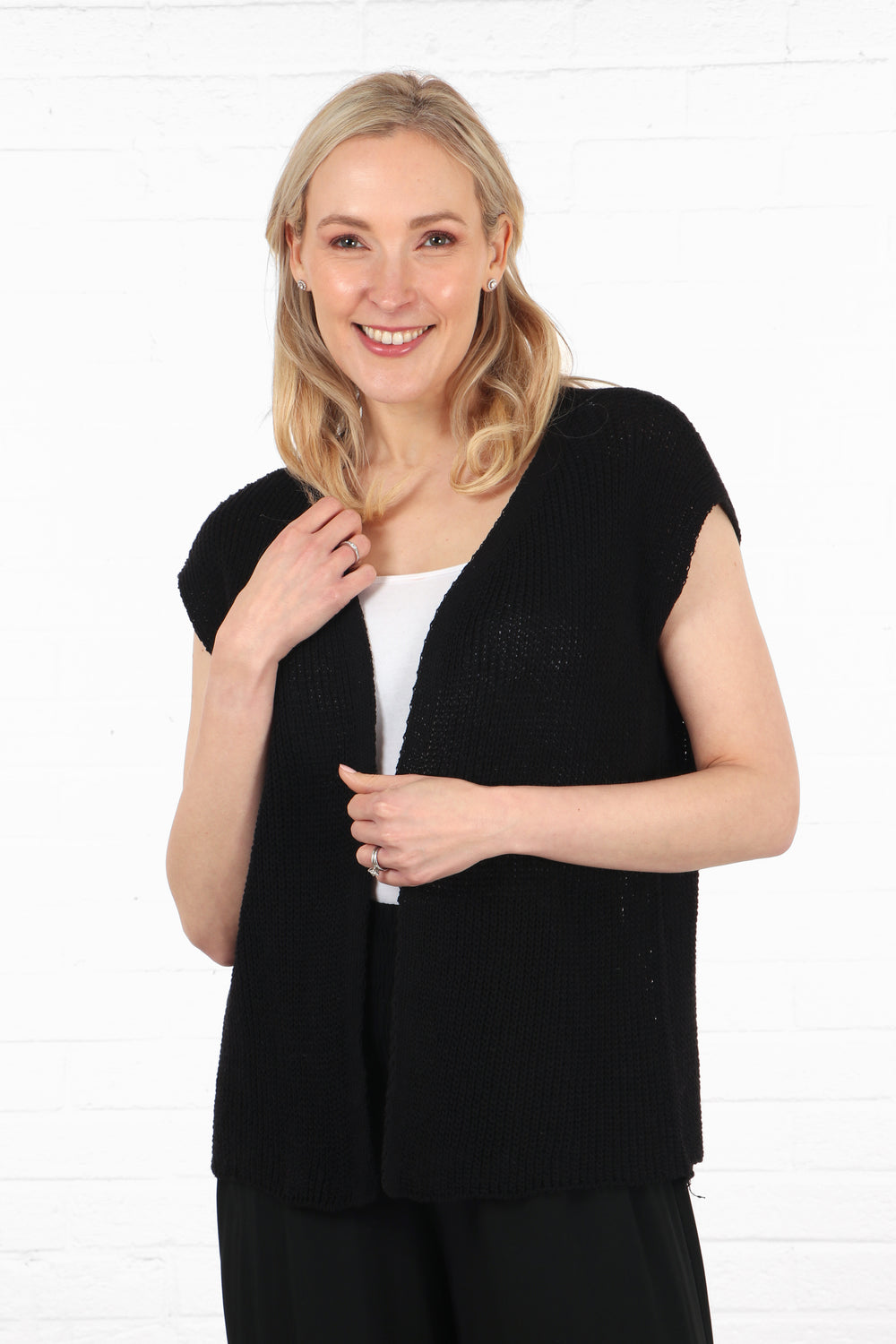 model wearing a navy blue knitted waistcoat with an open front