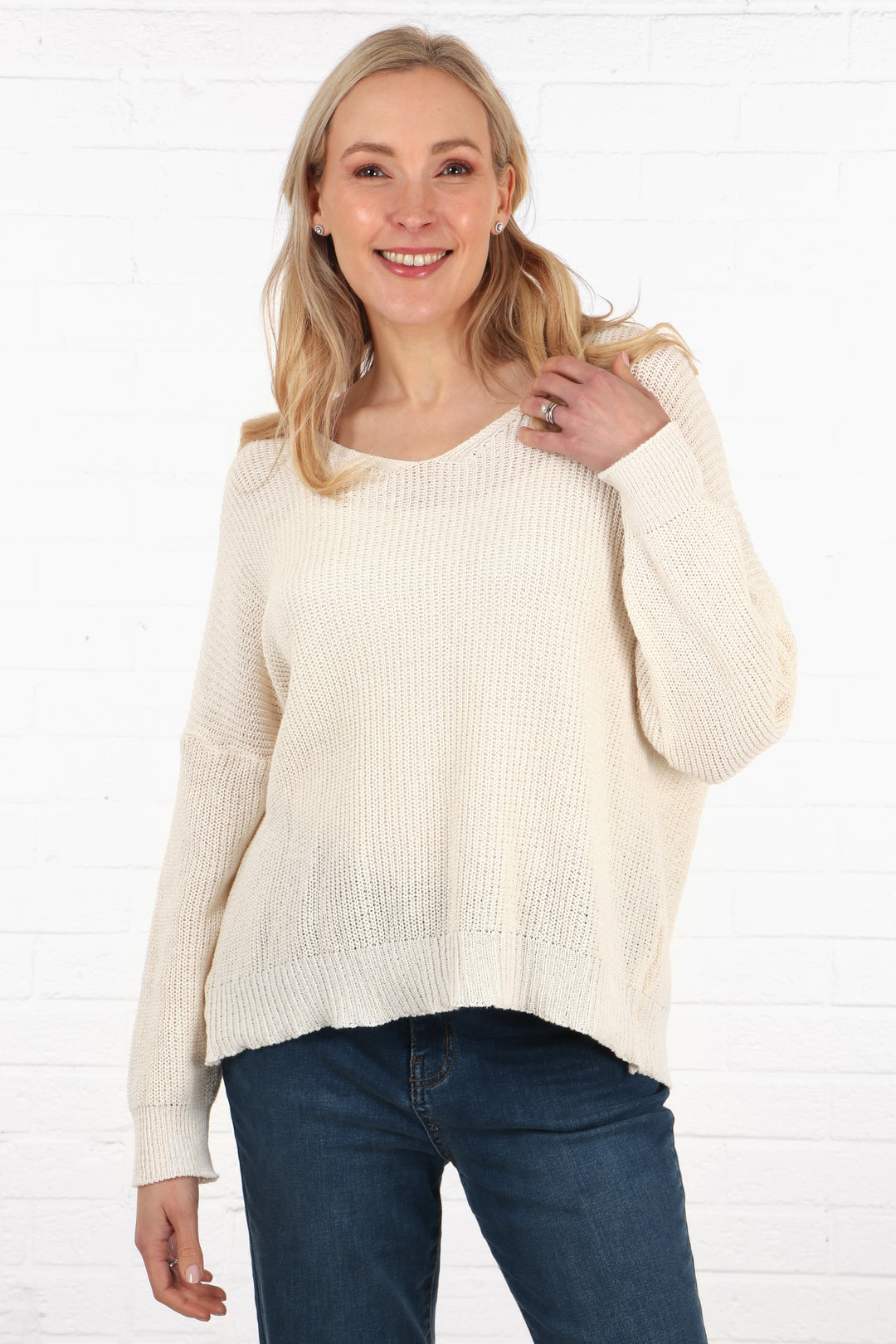 model wearing a lightweight cotton knitted jumper in cream