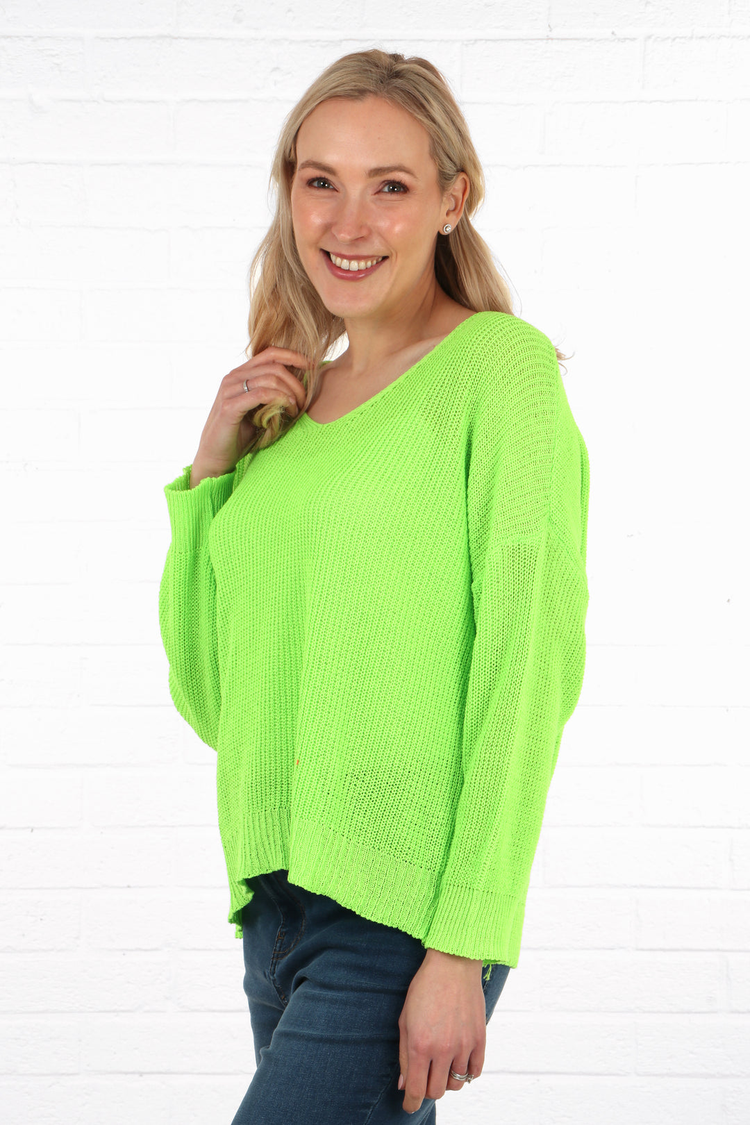 model wearing a long sleeve fine knit cotton jumper in lime green