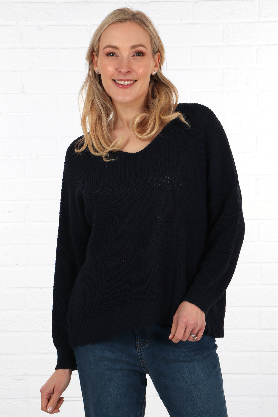 model wearing a navy blue knitted jumper made from natural cotton 