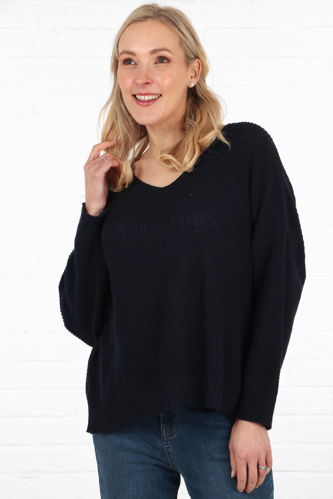 model wearing a plain navy blue knitted cotton jumper