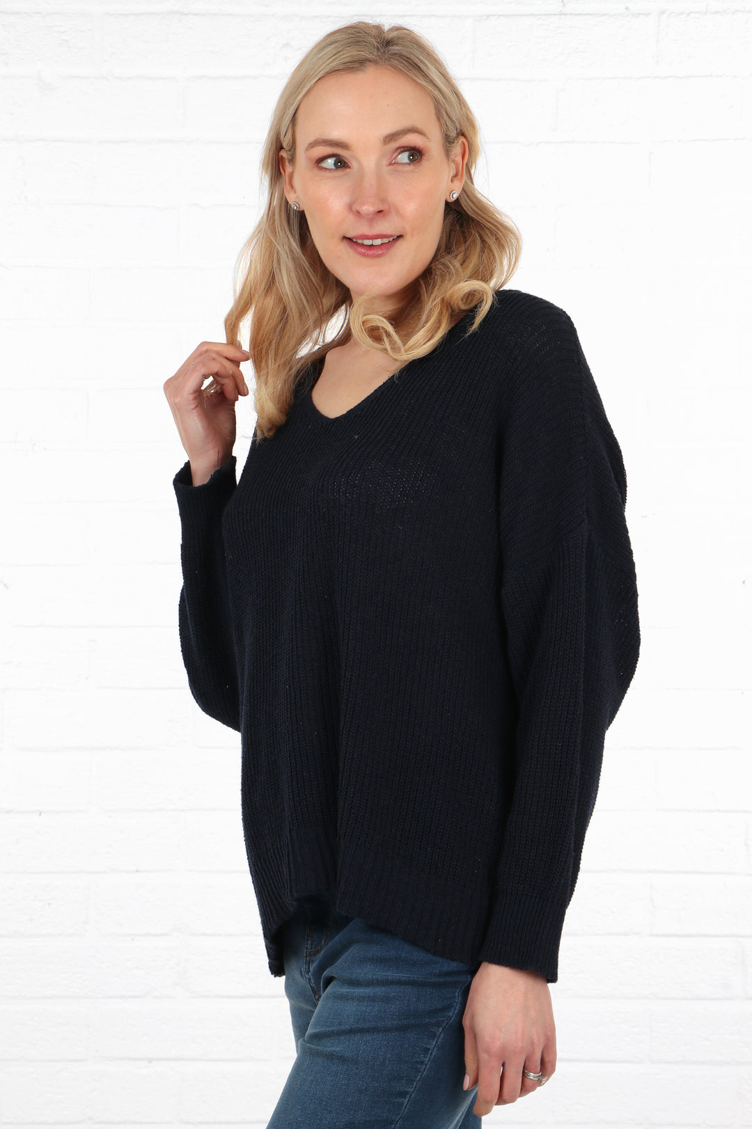 a plain navy blue long sleeve lightweight knitted cotton jumper being worn by a model