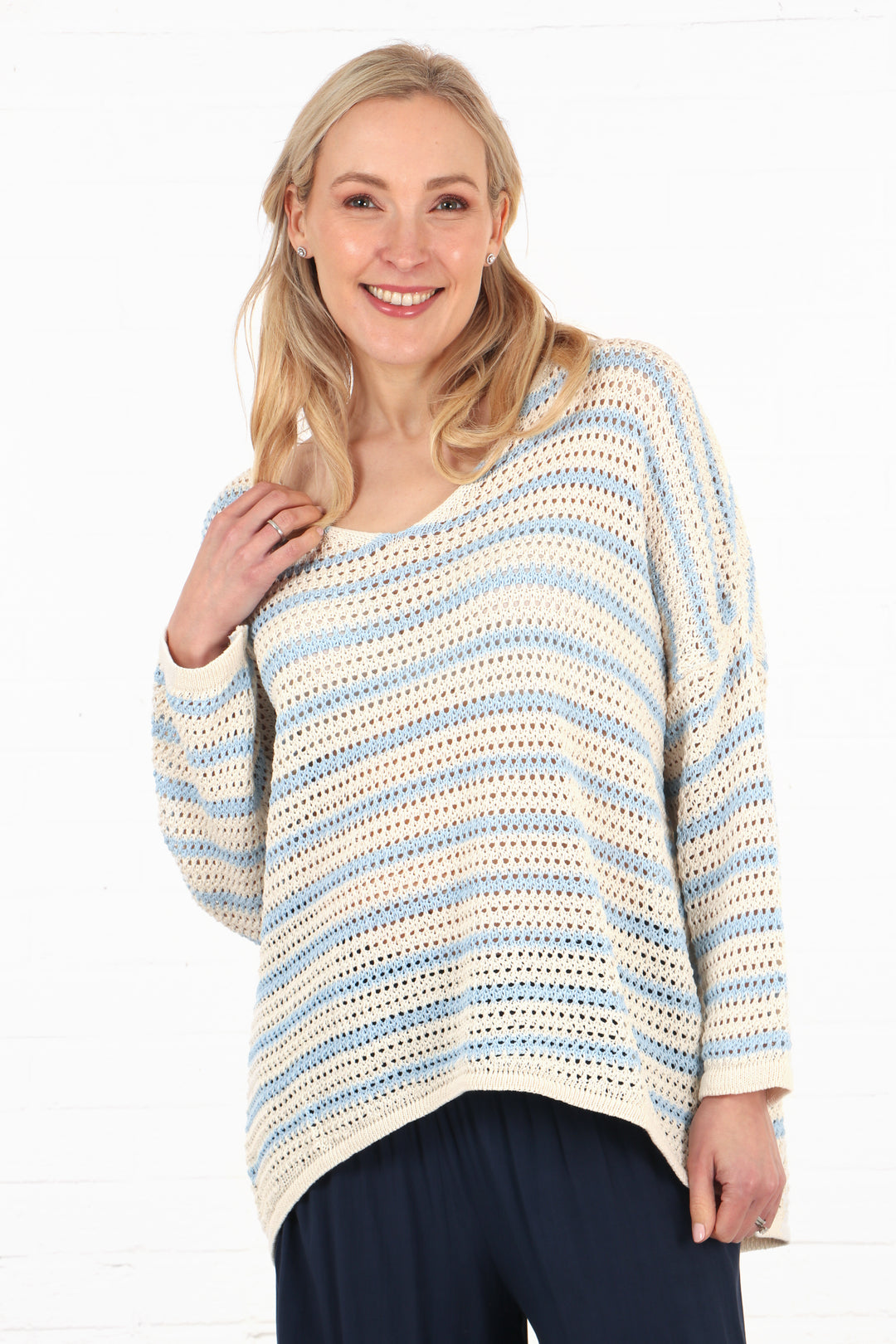 model wearing a cream and light blue striped cotton open knit jumper with long sleeves and a v-neck