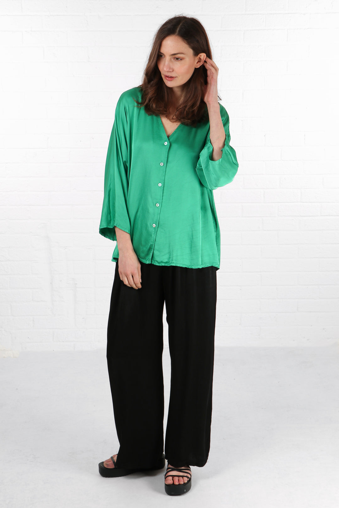 a green 3/4 sleeve silky blouse in a plain bright green