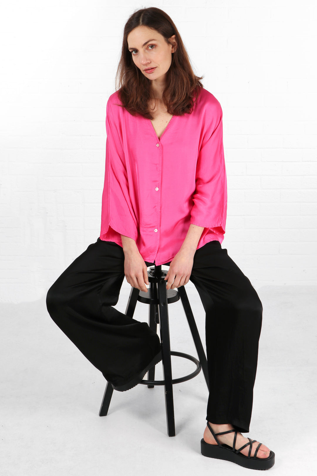 hot pink button down v neck blouse with a loose fitting design