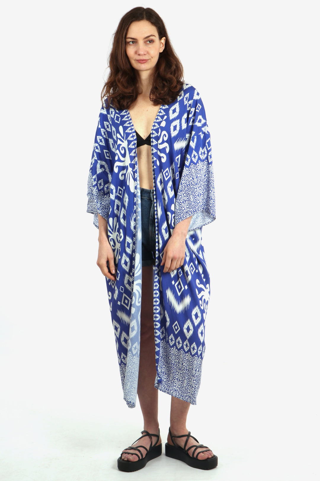 model wearing a long midi length blue and white ikat pattern kimono robe with 3/4 sleeves