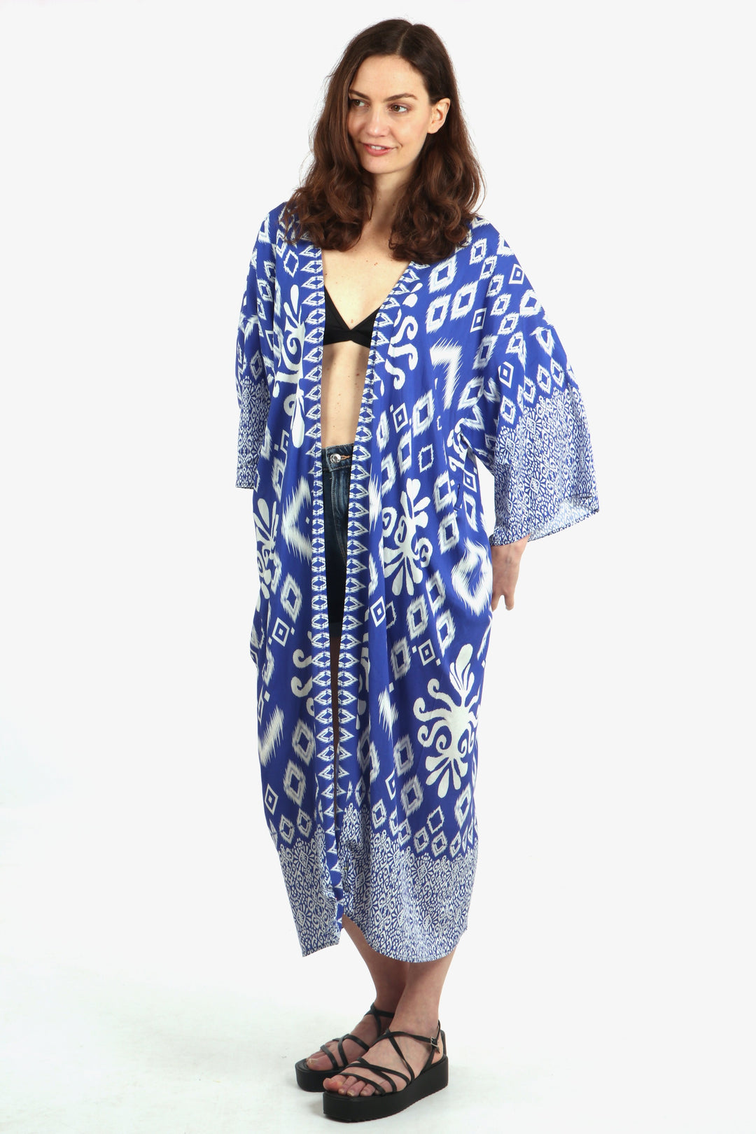 model wearing a blue ikat print kimono, showing that this robe can be worn as a beach cover up