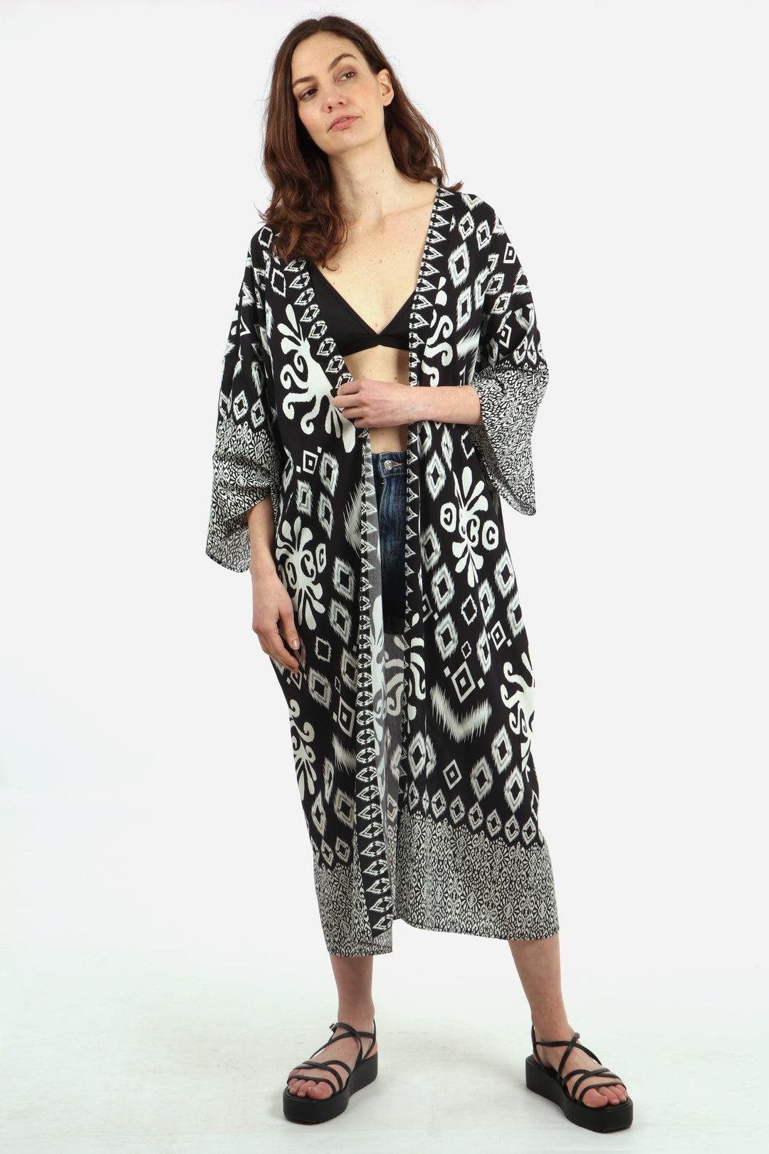 model wearing a black and white ikat pattern midi length kimono robe