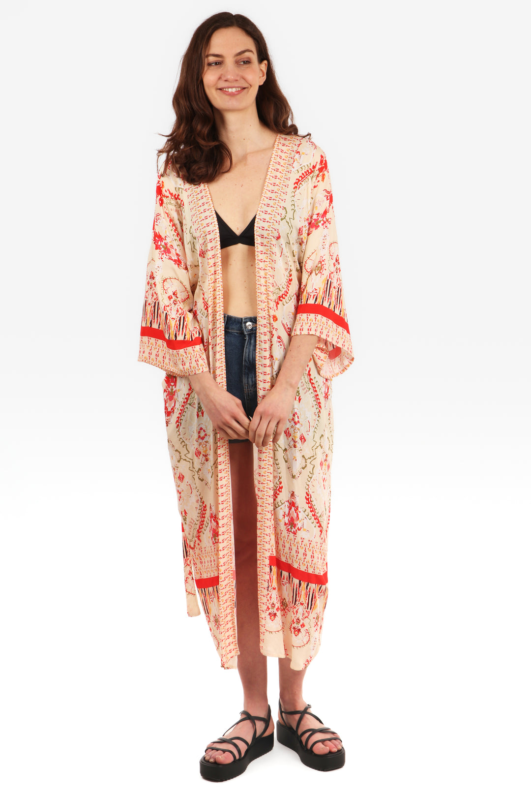 model wearing a midi length open front kimono robe with an ornate cream and pink mandala print pattern and 3/4 sleeves 