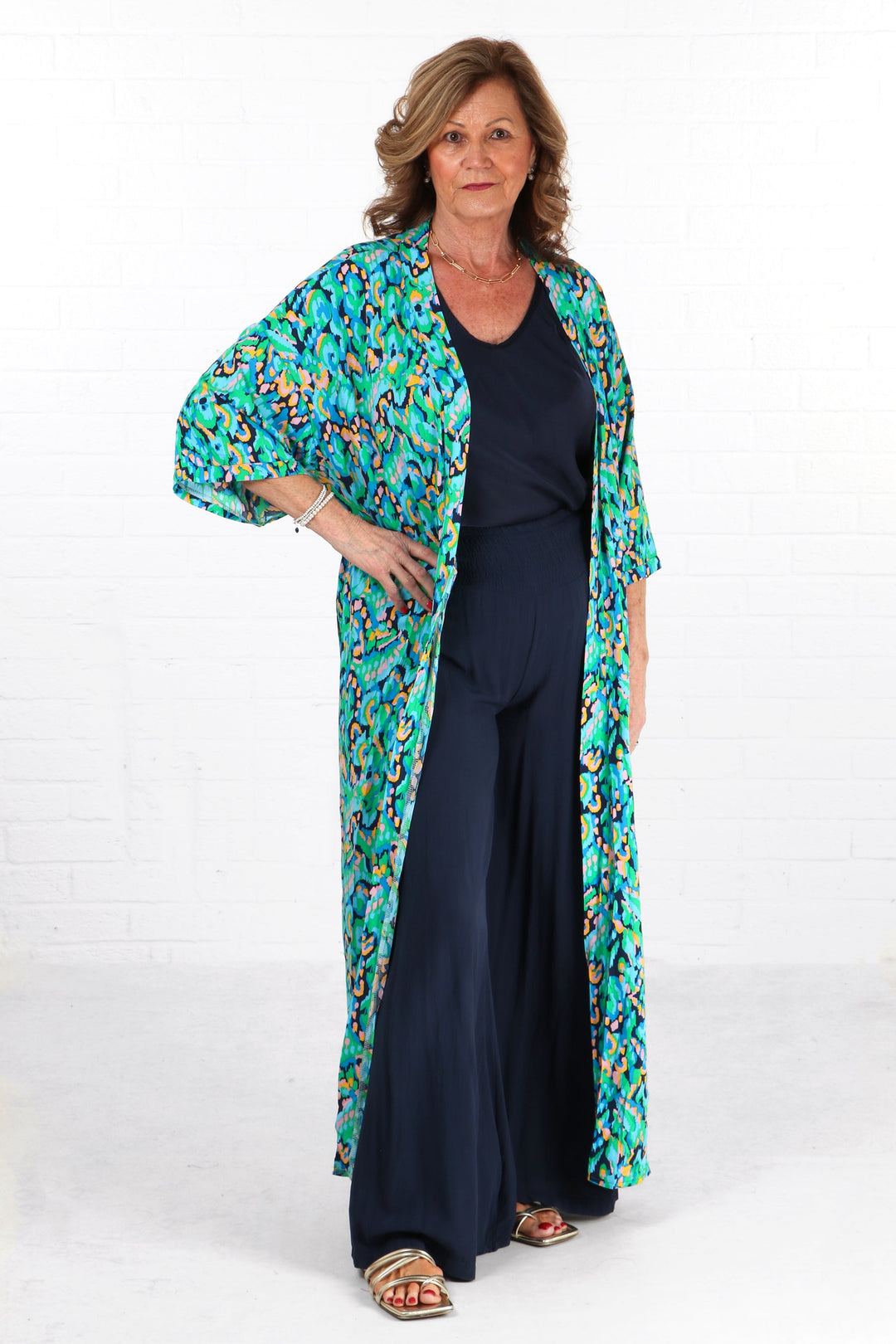 model wearing a green abstract print long kimono robe with 3/4 sleeves and a waist tie fastening