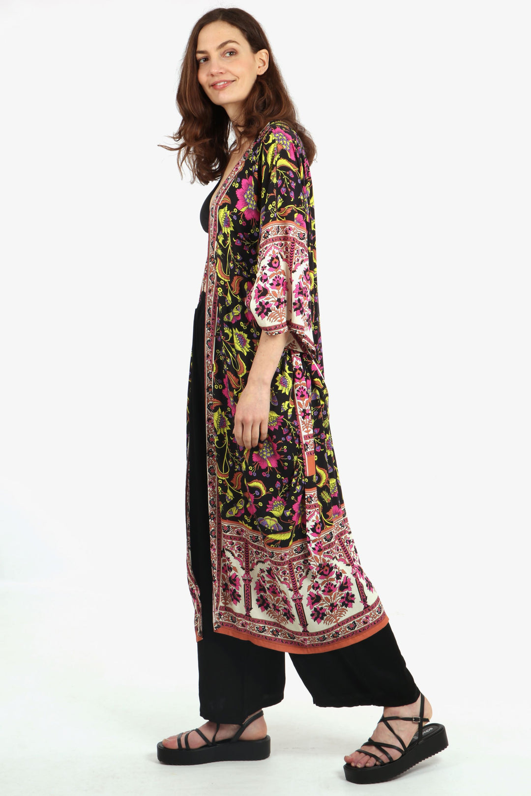 model wearing a black, pink and yellow ornate floral and butterfly patterned midi length kimono robe with 3/4 sleeves