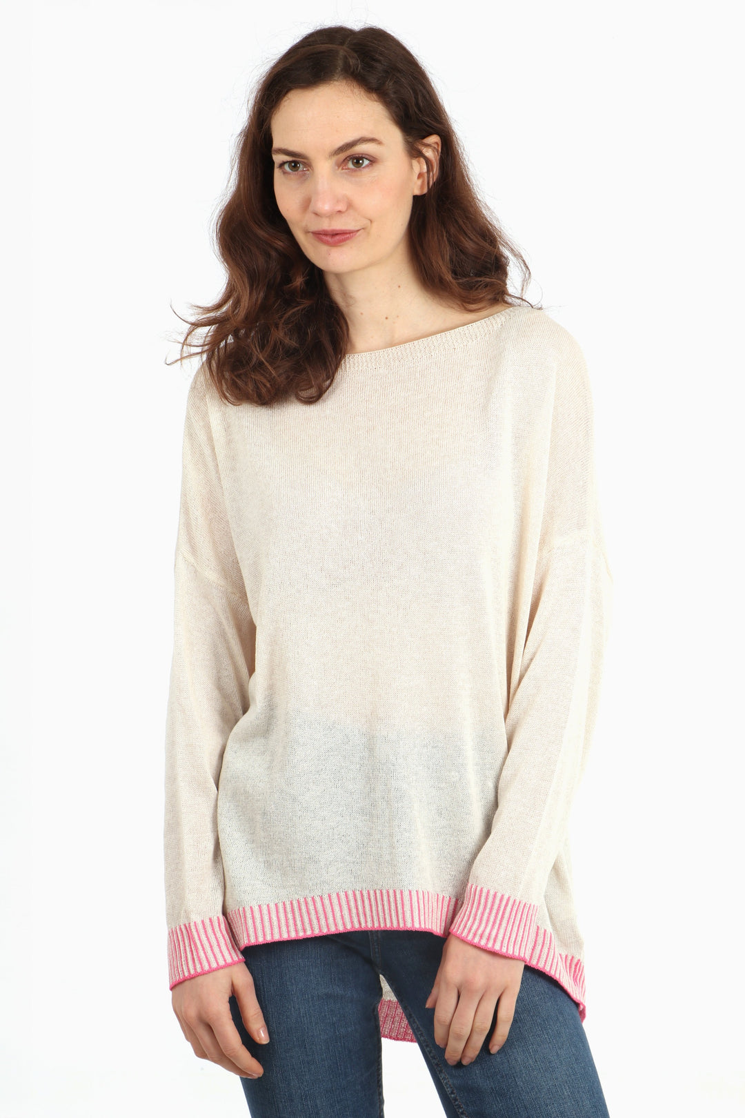 model wearing a long sleeve boat neck cotton jumper in cream with a contrasting fuchsia pink stitched hem and cuff