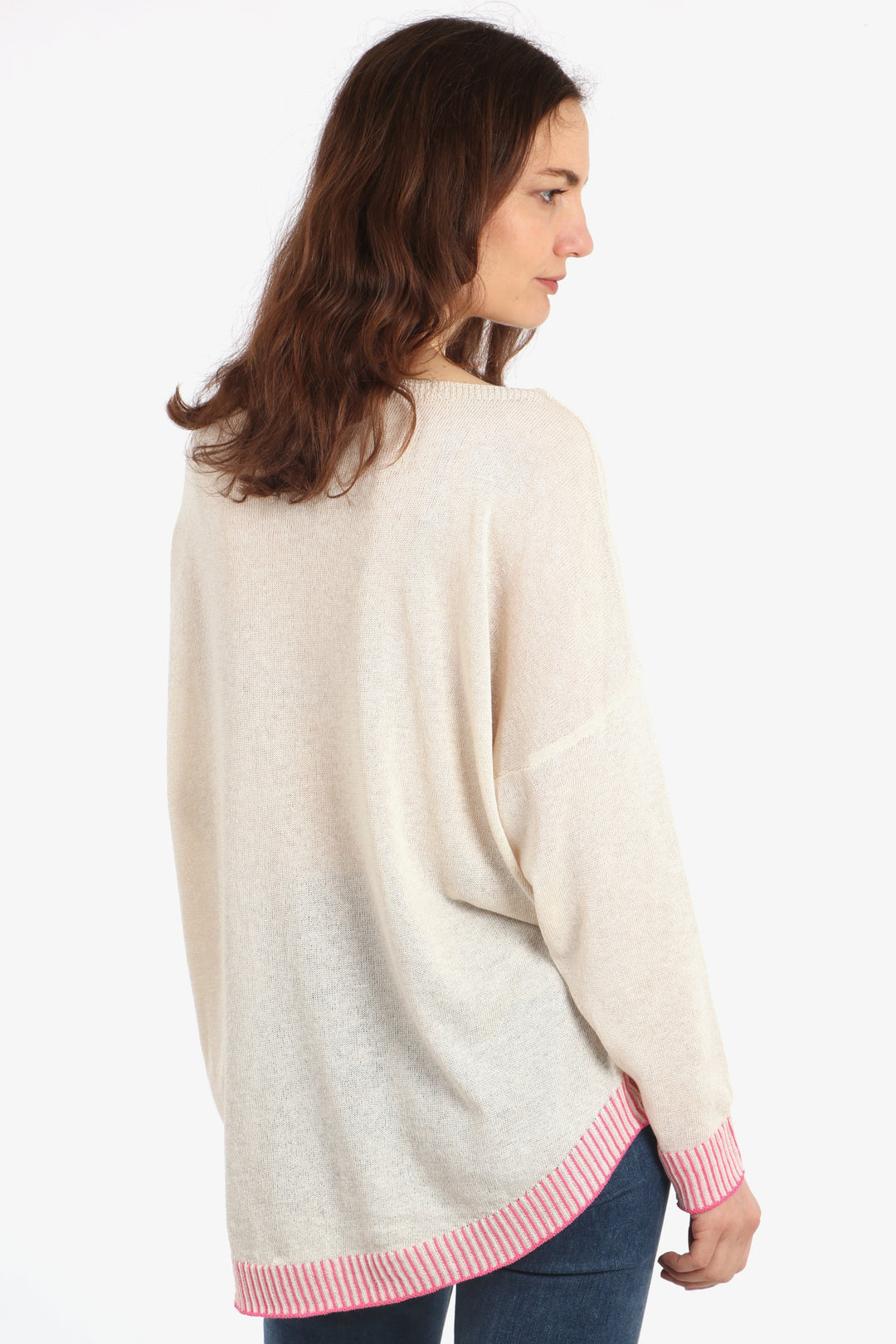 model showing the side of the jumper, showing the dip hem design where the jumper is longer at the back than the front