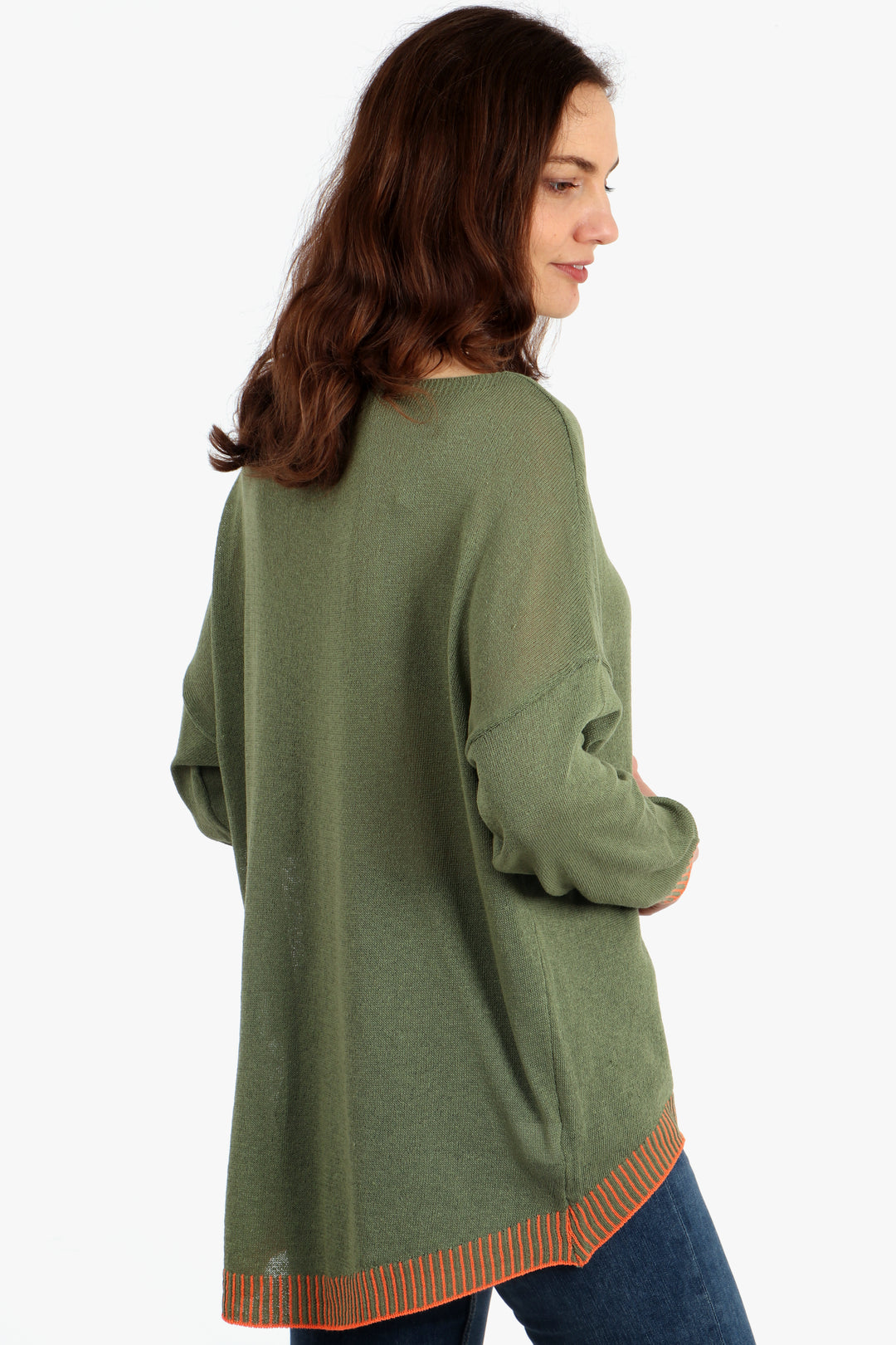 model showing the back of the jumper, showing the dip hem design where the jumper is longer at the back than the front