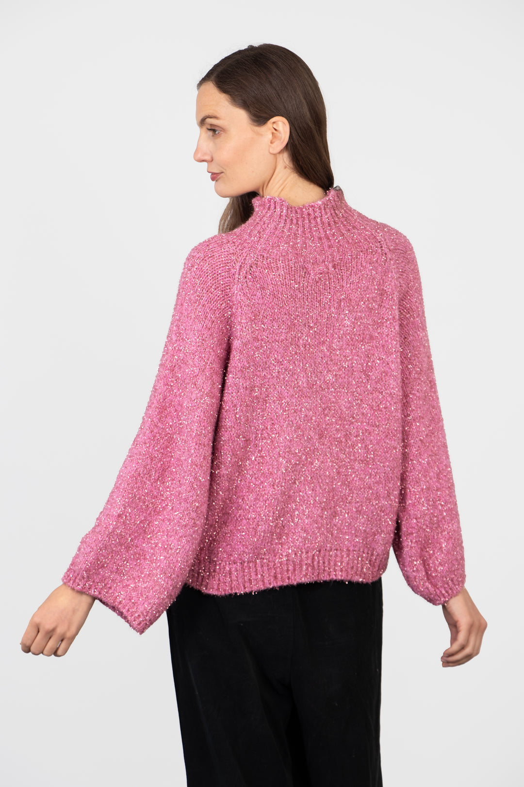 model showing the back of the jumper, the neck is high at the back and the sparkly effect is all over