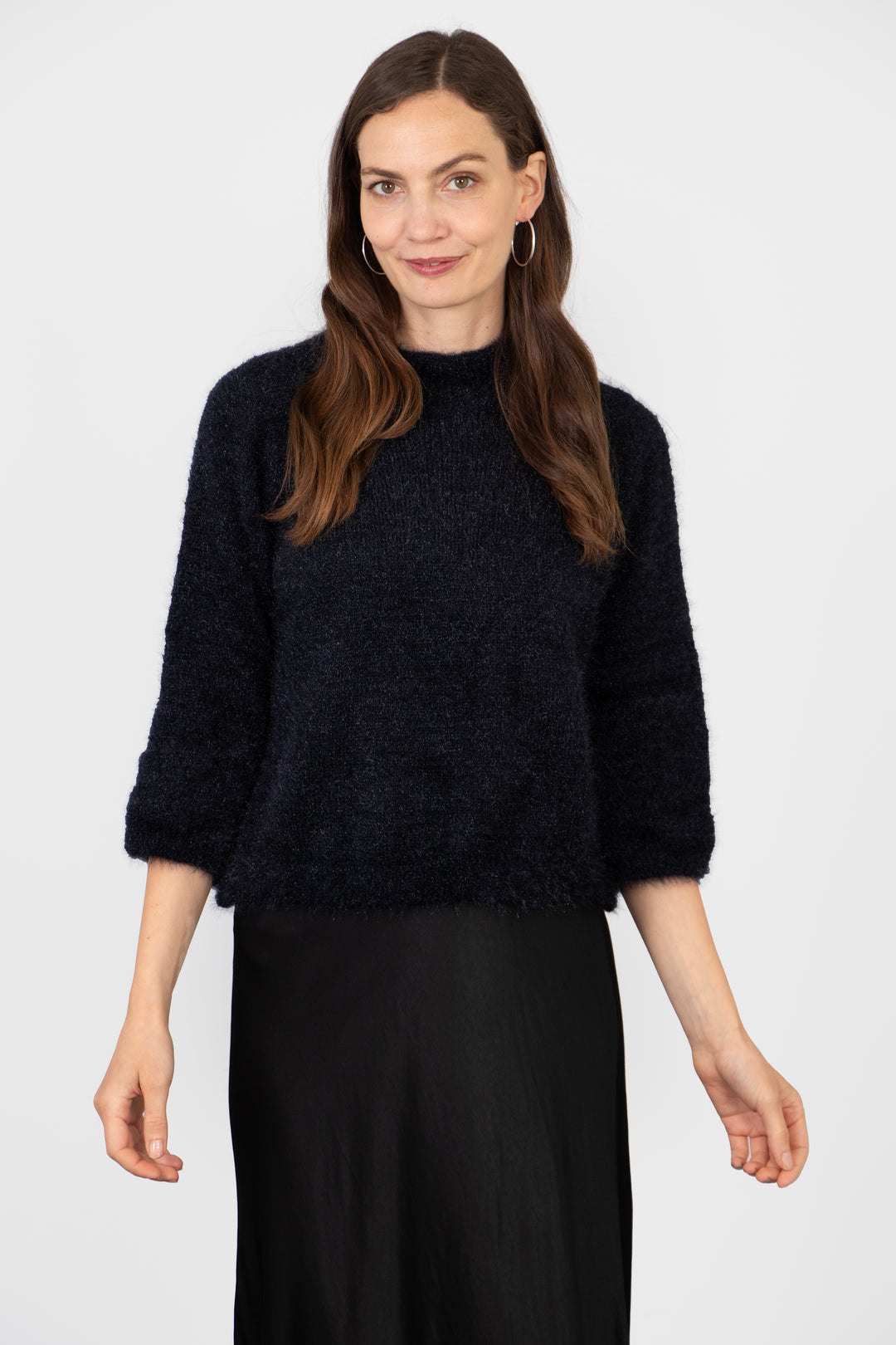 model wearing a plain navy blue box jumper with 3/4 sleeves and a mohair texture knitted fabric