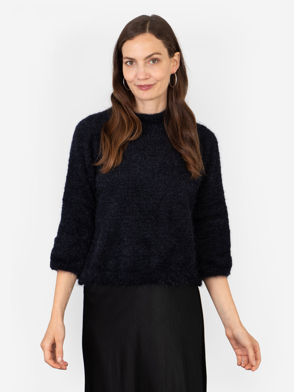 model wearing a plain navy blue box jumper with 3/4 sleeves and a mohair texture knitted fabric