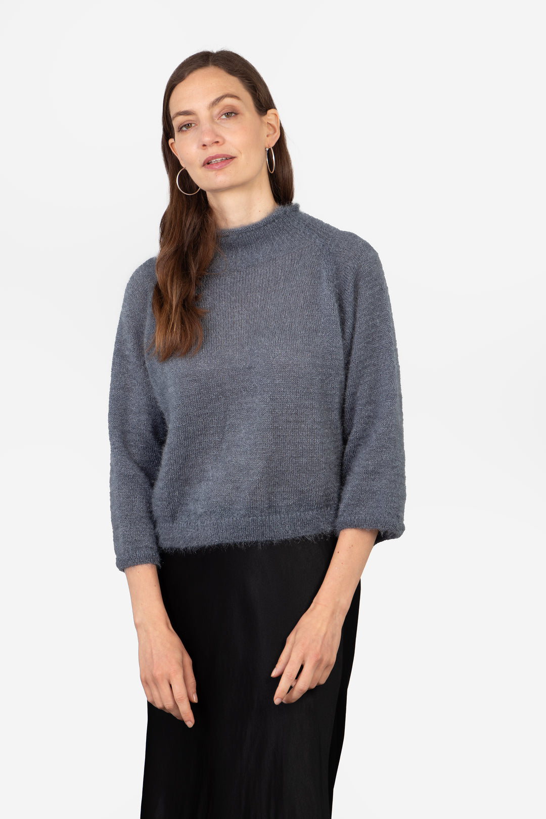 model wearing a plain grey box jumper with 3/4 sleeves and a mohair texture knitted fabric