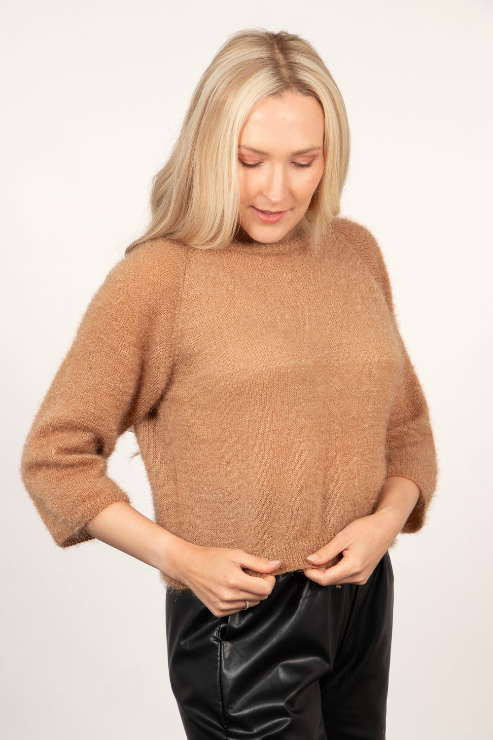 model showing that the jumper is cropped in length and sits just above the hips 