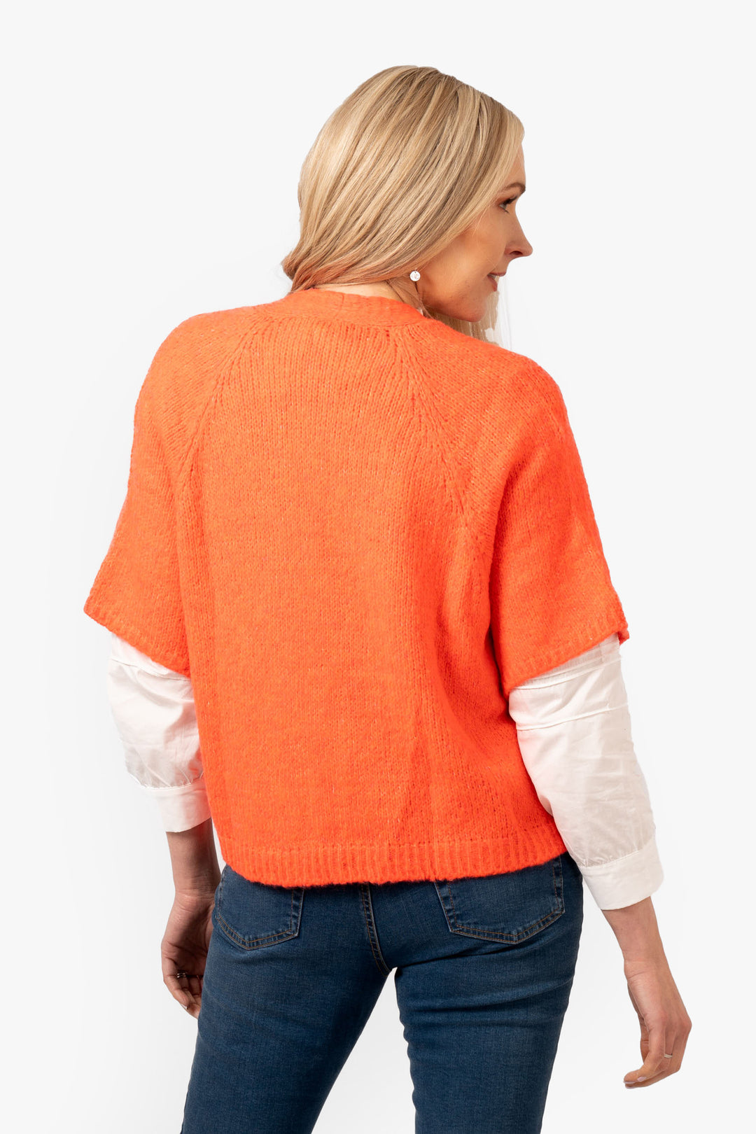amelia-short-sleeve-wool-blend-cardigan-coral-model-showing-the-back-of-the-piece-the-sleeves-are-elbow-length