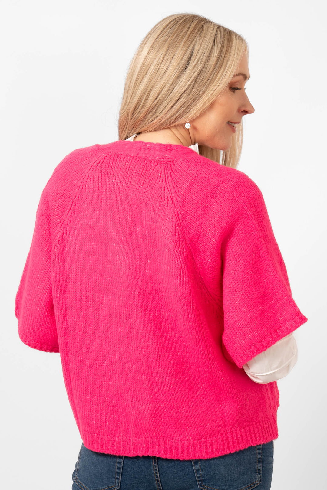 amelia-short-sleeve-wool-blend-cardigan-fuchsia-model-showing-the-back-of-the-cardigan