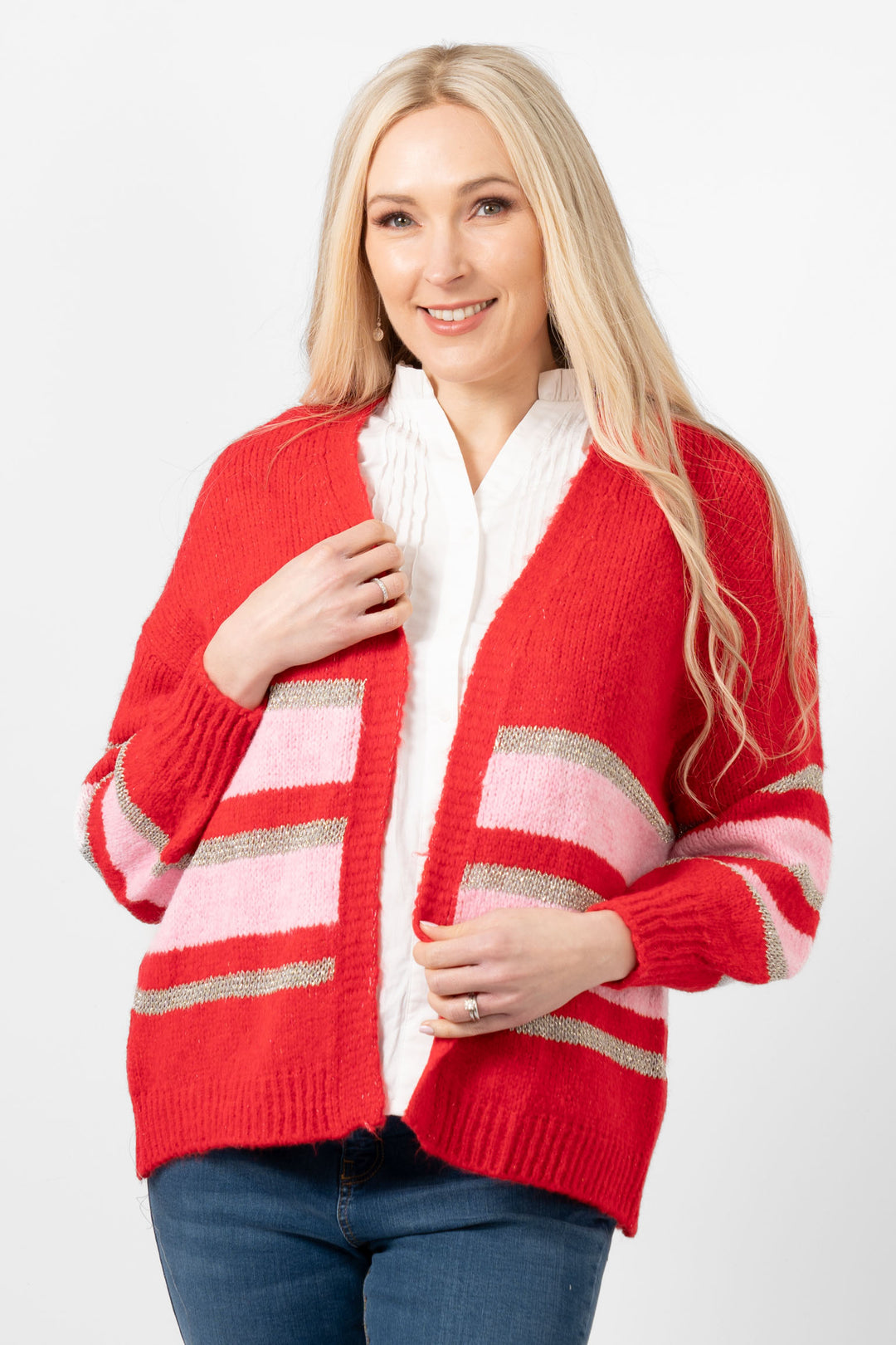 model wearIng a red, pink and gold glitter striped open front knitted cardigan. the cardigan had long sleeves and a v-neck and falls at the hips.