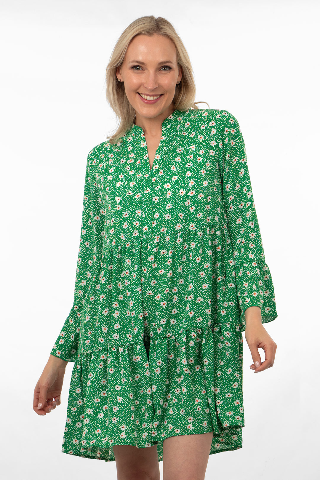 model wearing a green daisy floral print midi dress with long floaty sleeves and a tiered hem, the dress has a grandad style collar