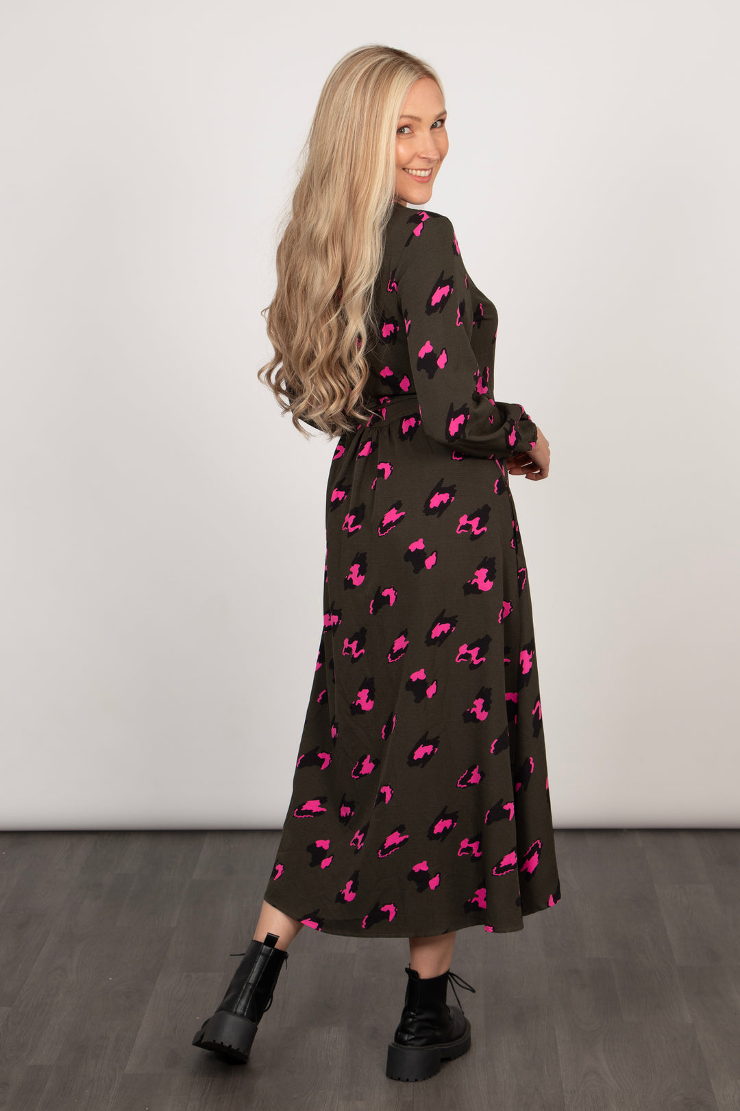 model showing the back of the dress which is longer than the front. the back of the dress is midaxi or maxi length depending on height