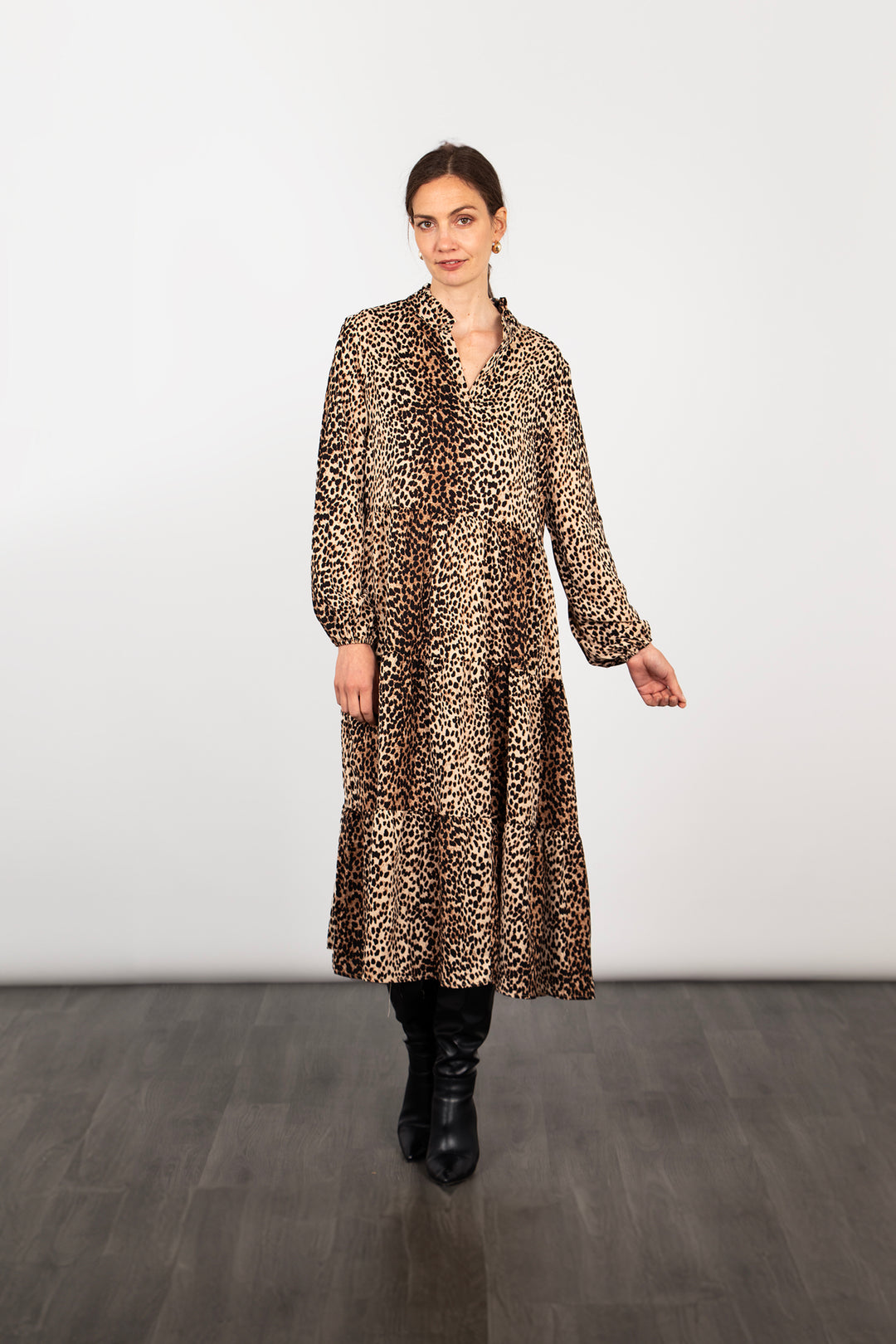 model wearing a long sleeve tiered neutral leopard print midi dress with a subtle v-neck and frilled collar