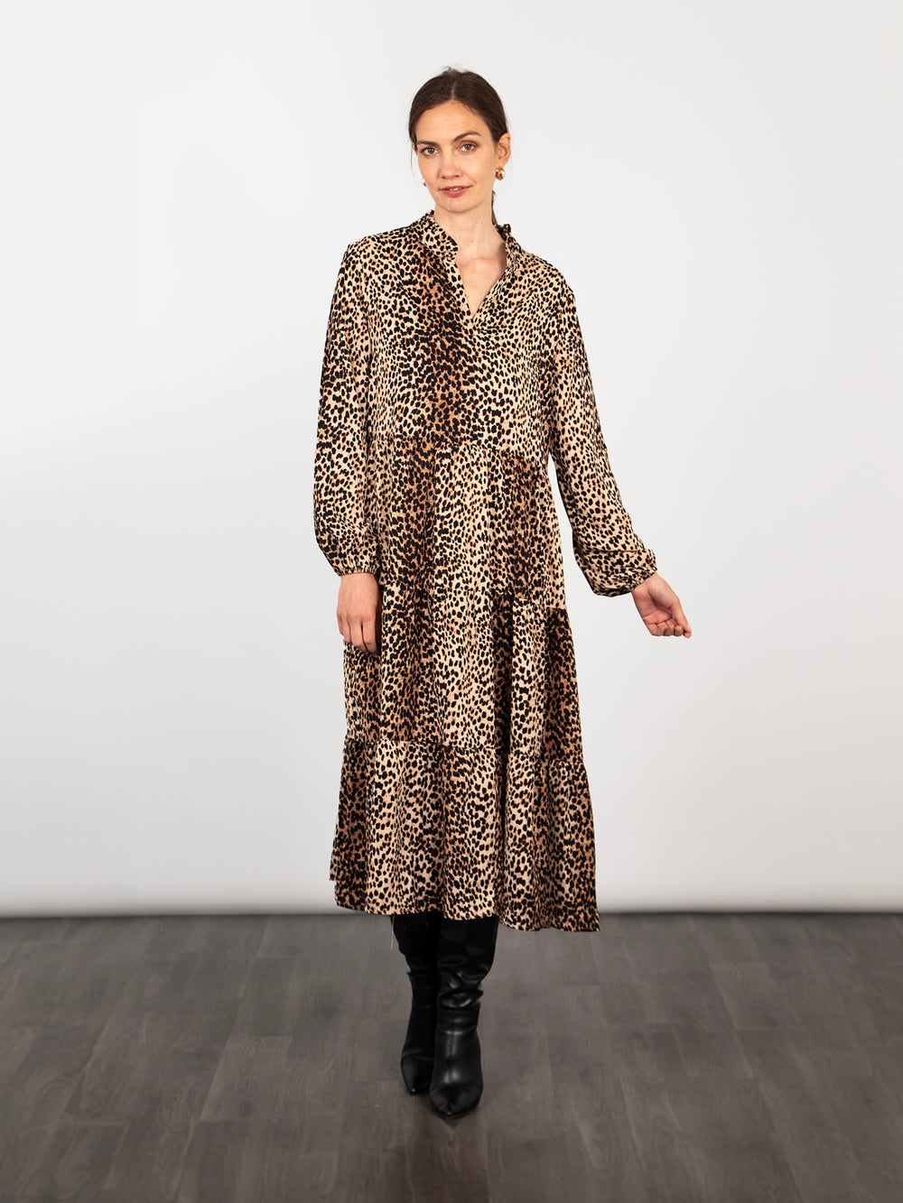 model wearing a long sleeve tiered neutral leopard print midi dress with a subtle v-neck and frilled collar