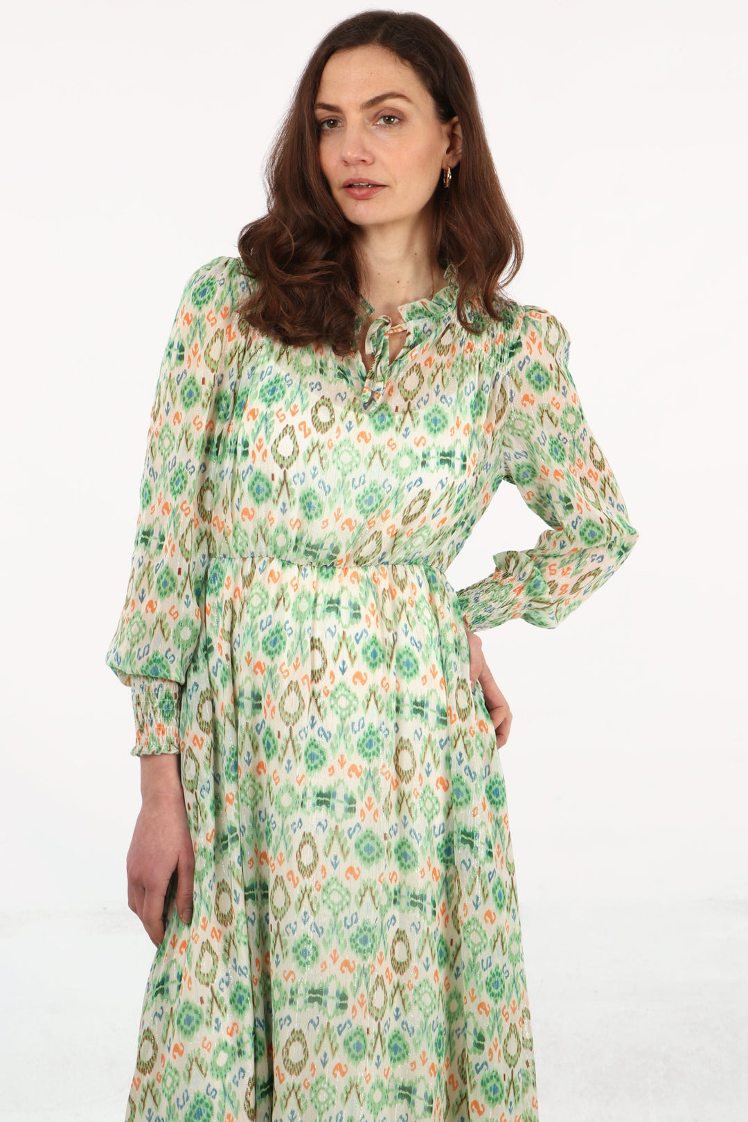 close up of the green ikat pattern, the shirred cuffs on the long sleeves are also highlighted