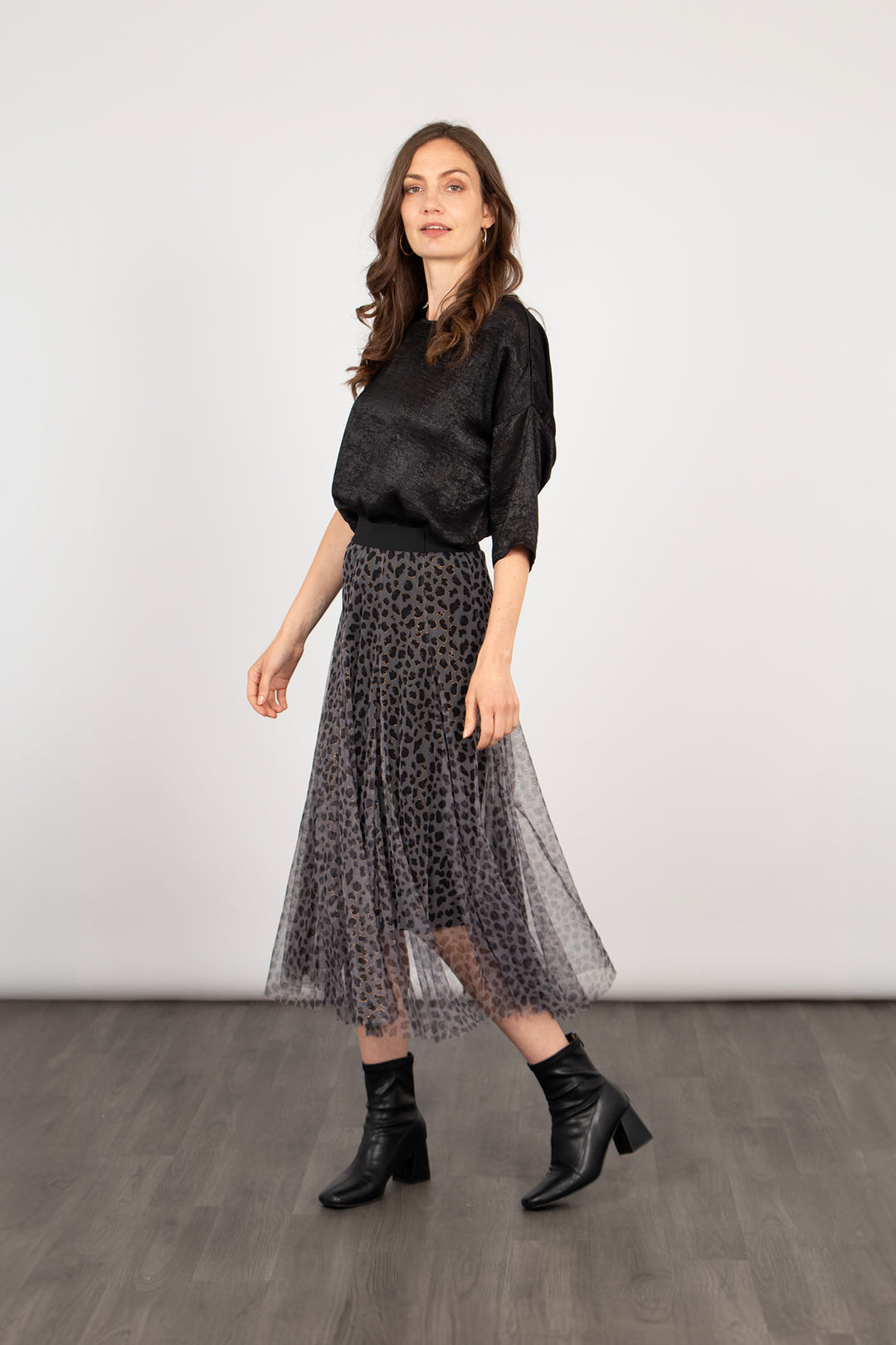 model wearing a grey tulle leopard print midi skirt, the skirt has an elasticated waist band