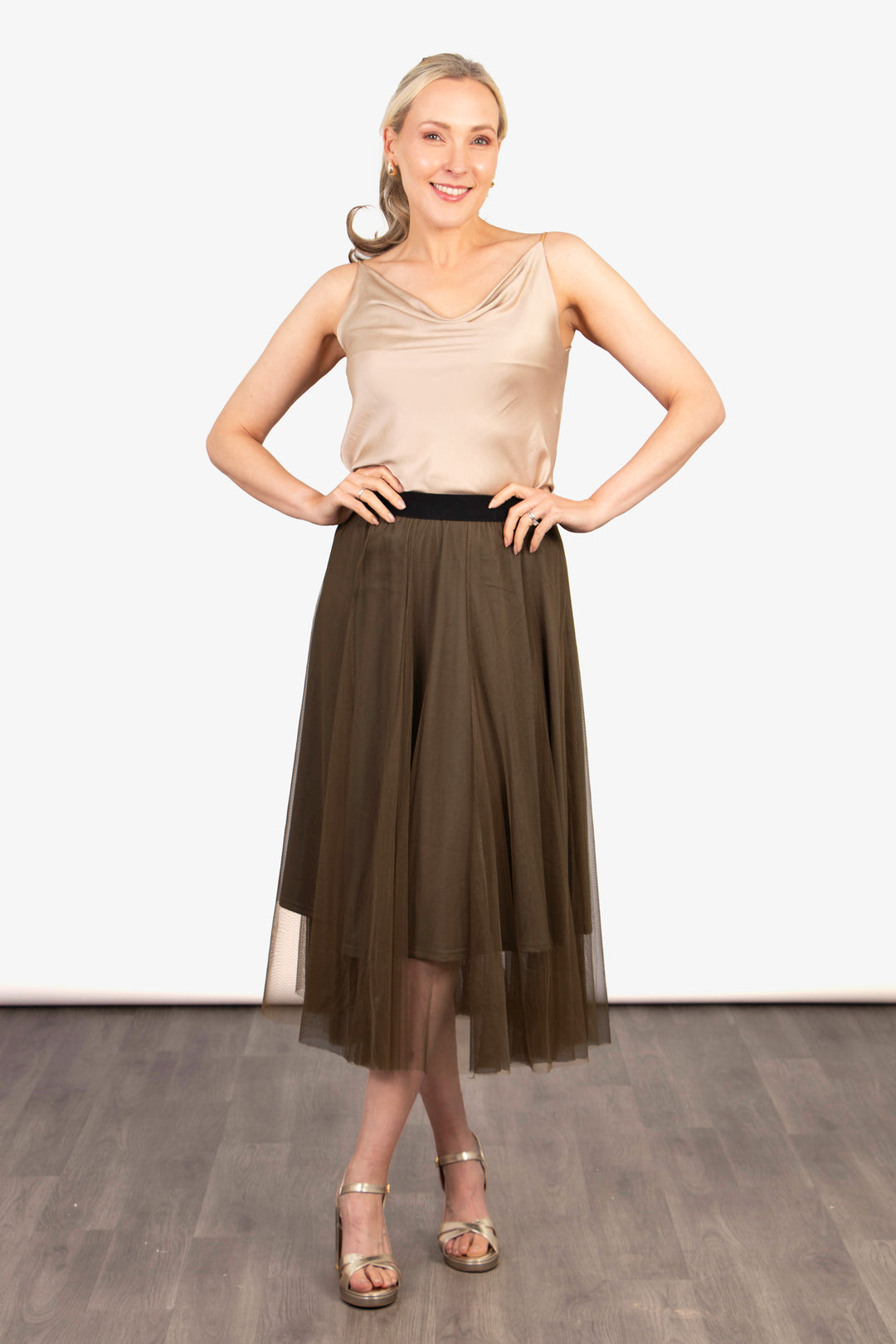 model wearing a plain khaki green tulle ruffled midi skirt