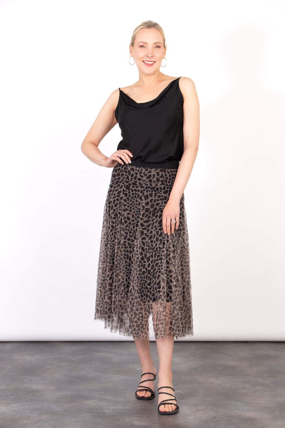 model wearing a tulle midi skirt with a neutral leopard print layer and elasticated waist