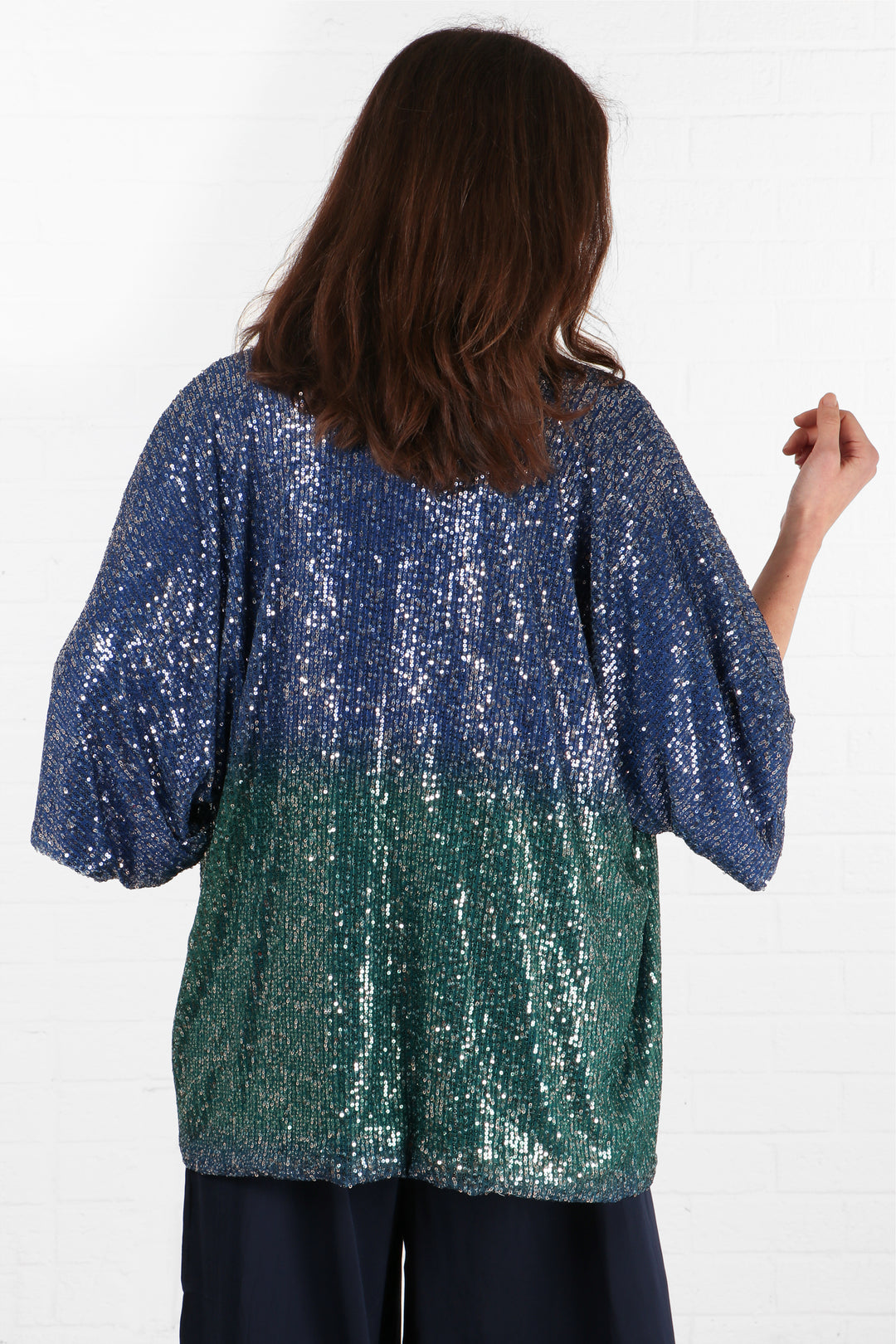 model showing the back of the kimono jacket showing the blue at the top and green at the bottom of the ombre effect