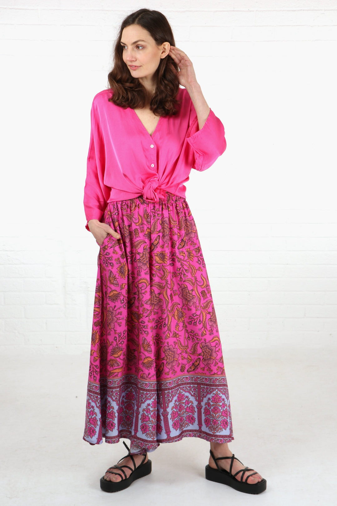 wide leg palazzo trousers in pink with an ornate floral and butterfly pattern, the palazzos have pockets