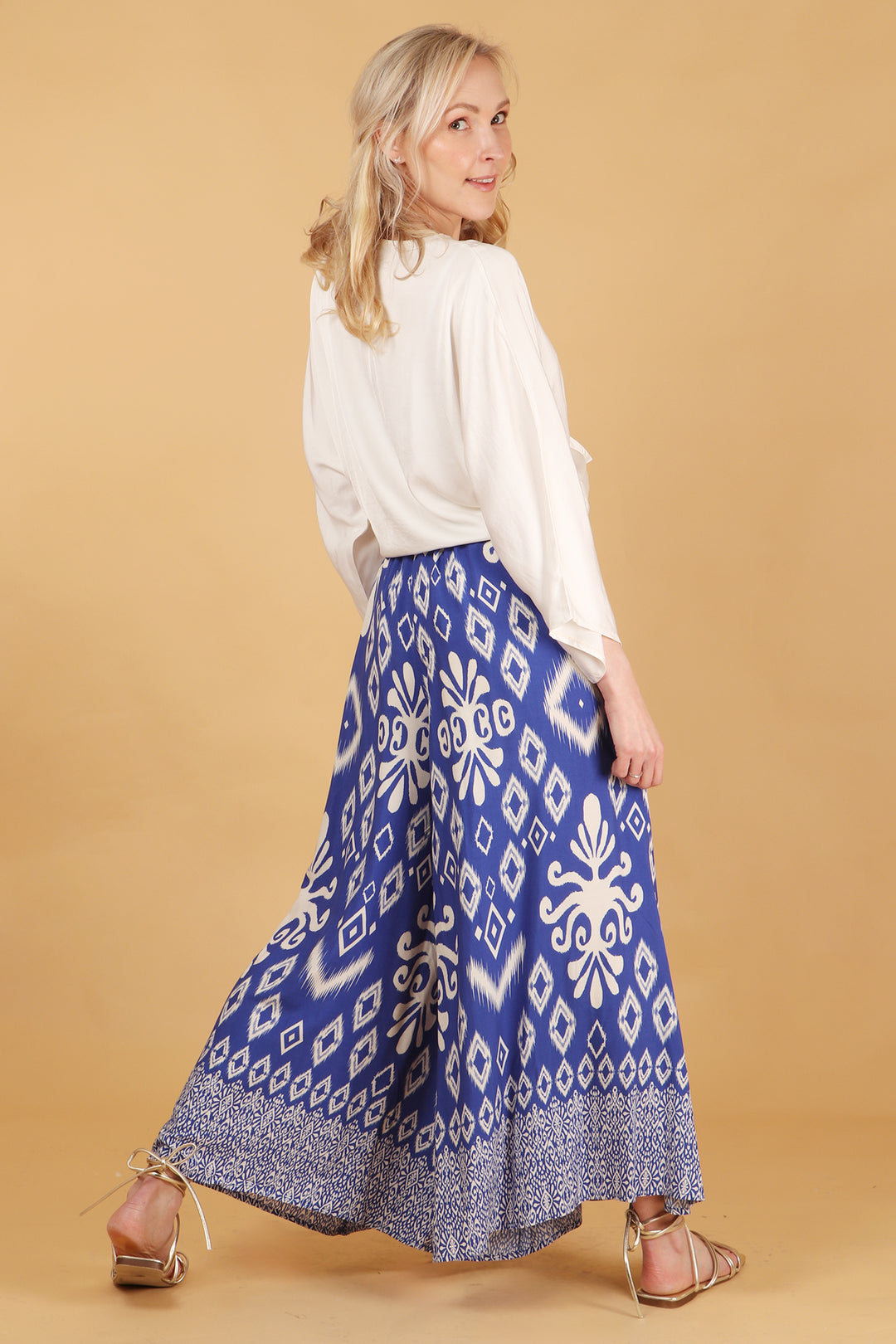 model showing the back of the palazzo pants showing an all over ikat pattern 
