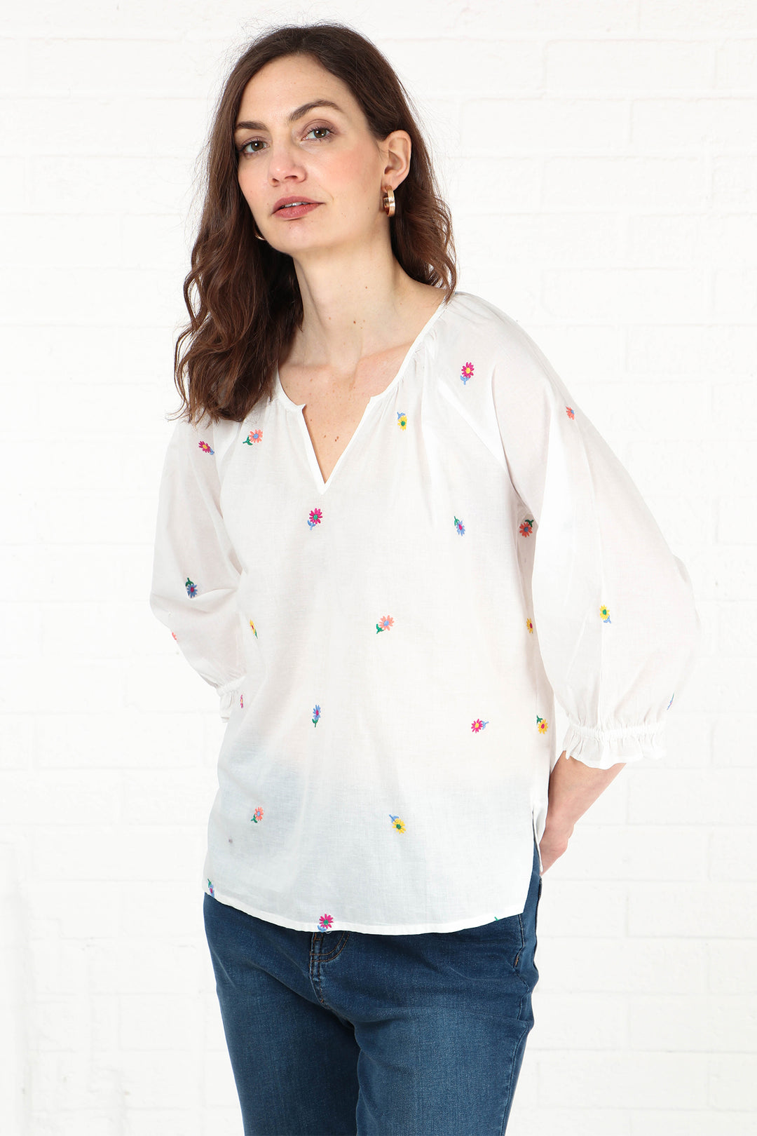 close up of the cotton blouse, showing in detail the multicoloured embroidered floral pattern