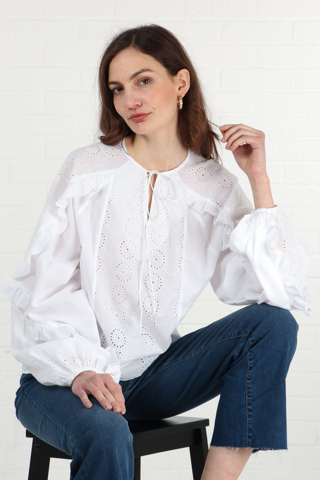 model wearing a white long sleeve broderie anglaise shirt in pure white cotton
